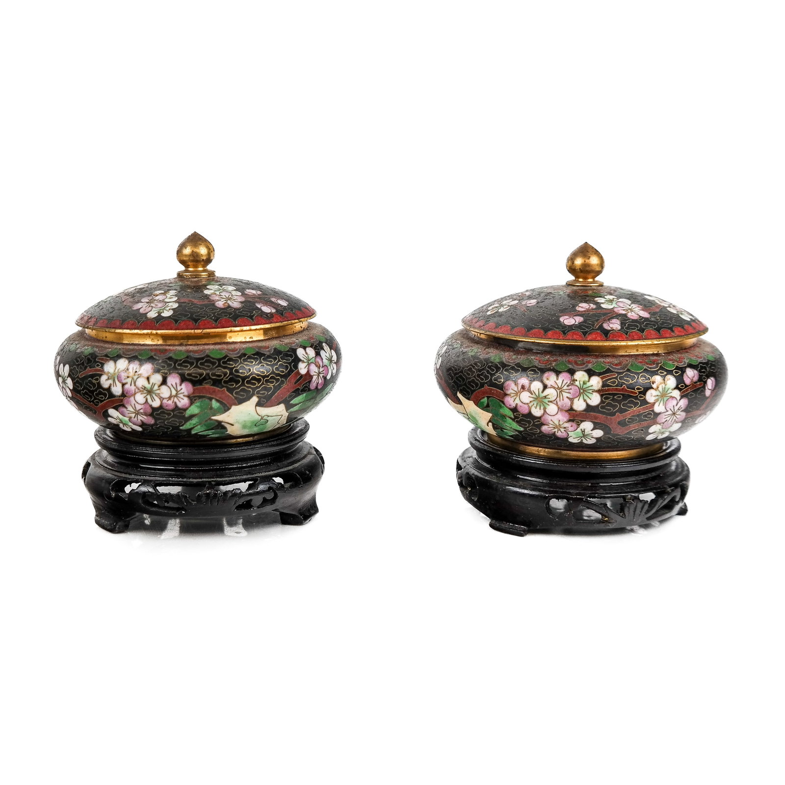 Pair of Chinese Cloisonne Lidded Bowls: Pair of Chinese cloisonne bowls, probably antique, depicting a cloud motif with blooming cherry blossoms, now on carved wood stands. [3 1/4" H x 4" Diam.]. Condition reports and requests for additiona