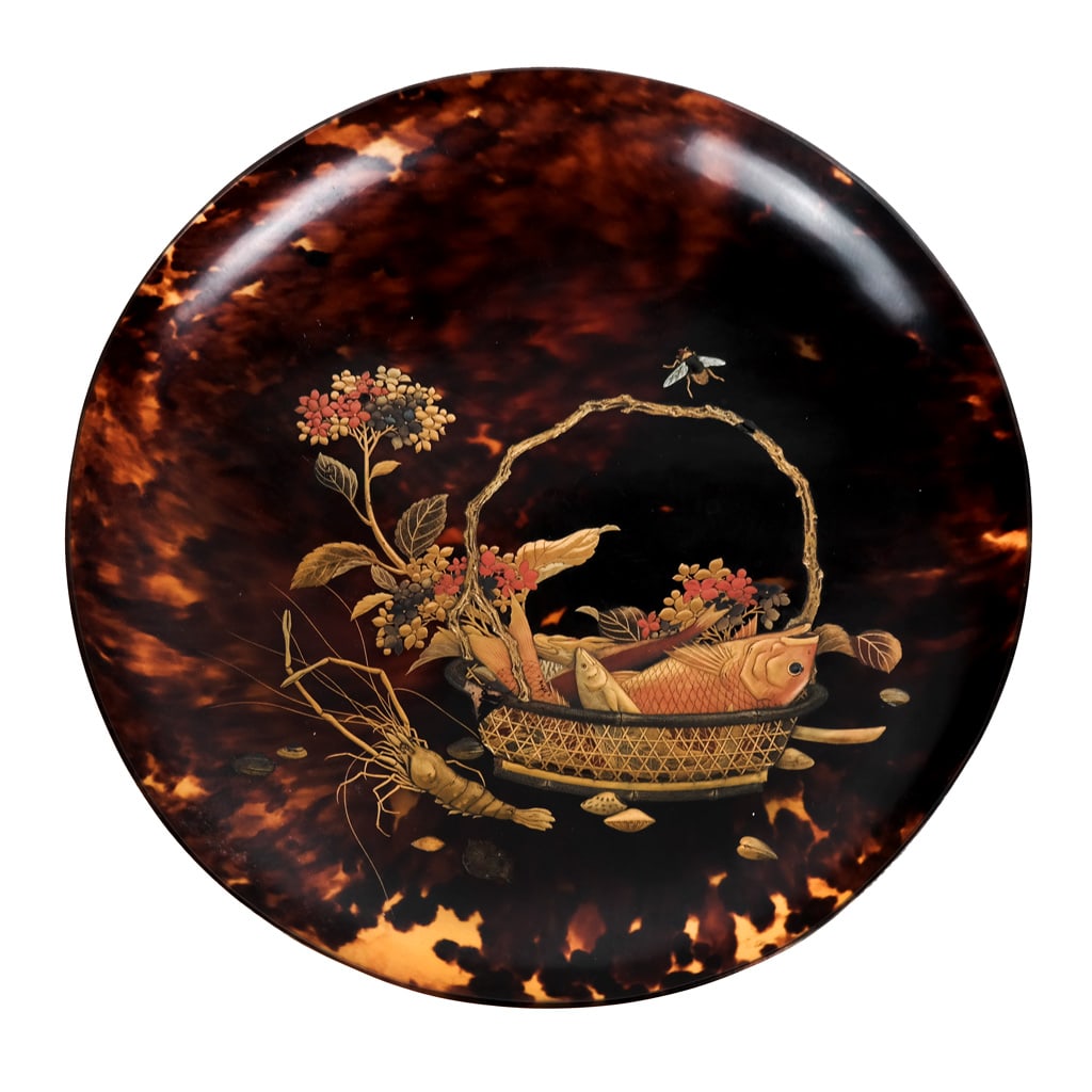 Gilt-Accented Shell Bowl: 19th century gilt-accented shell bowl with Shakudo-style relief and inlay of a basket with flowers, insects and fish, emblematic of Guanyin (Kannon/Kanzeon). [9 1/4" Diam.]. Some losses to inlay; crac