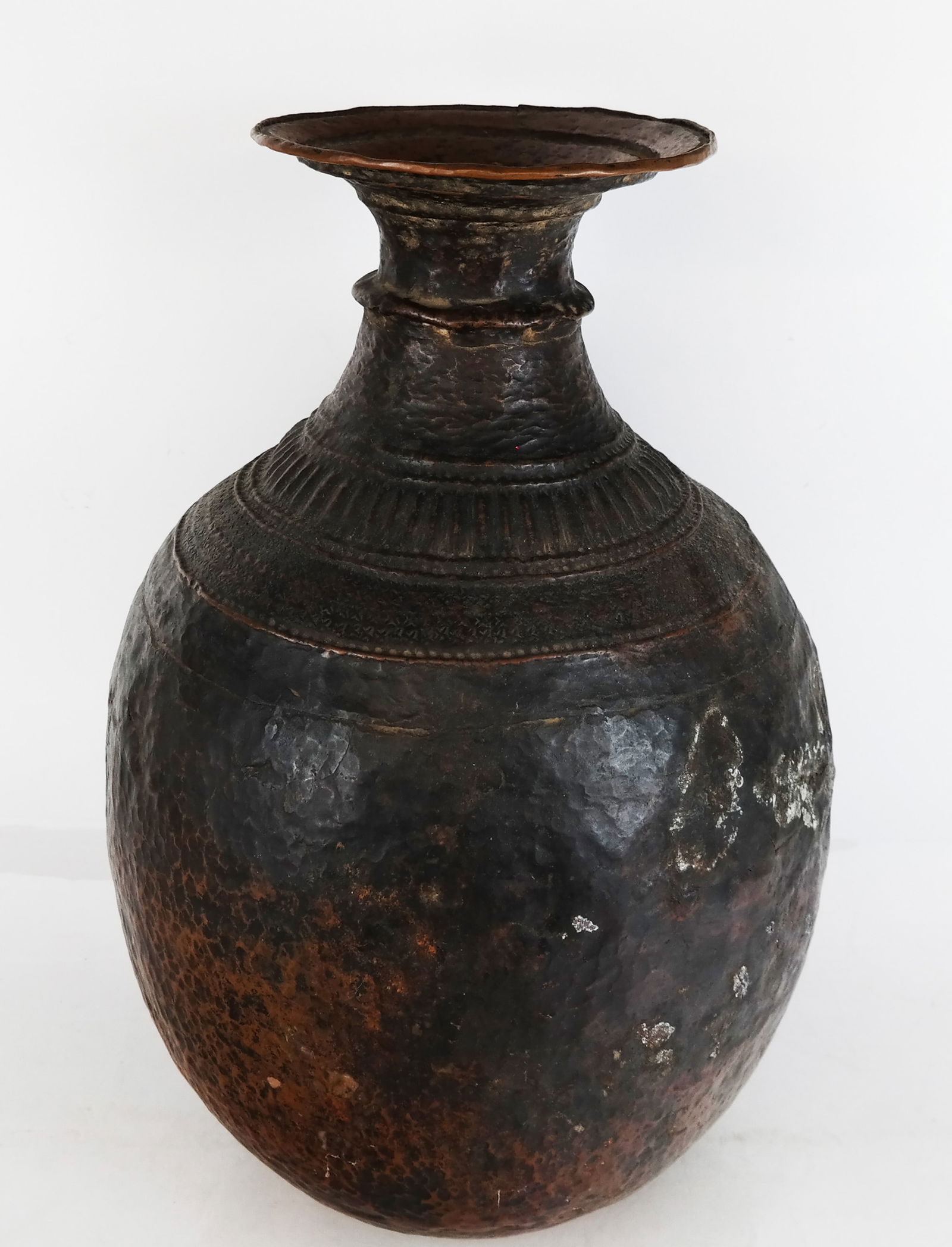 Southeast Hammered Copper Vase: Southeast hammered copper vase, possibly Tibetan. [18 3/4" H x 13" Diam.]. Holes, dents, residue and wear. Assembled group of glass and crystal with various cut patterns, the large bowl marked "Brierl