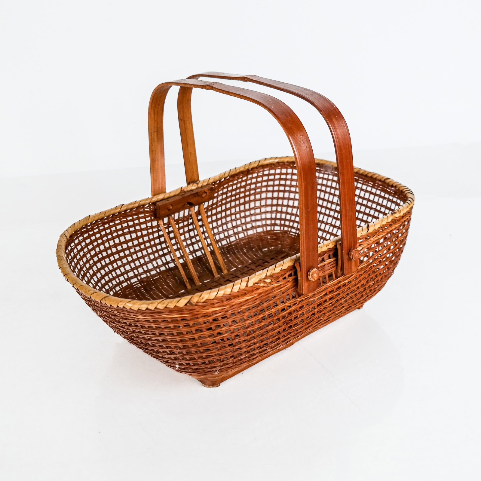 Nantucket Woven Basket: Nantucket woven basket with handles. [5" H x 13 1/2" W x 9" D]. In good condition. Condition reports and requests for additional photos cannot be accepted on this lot; please bid accordingly. This is 