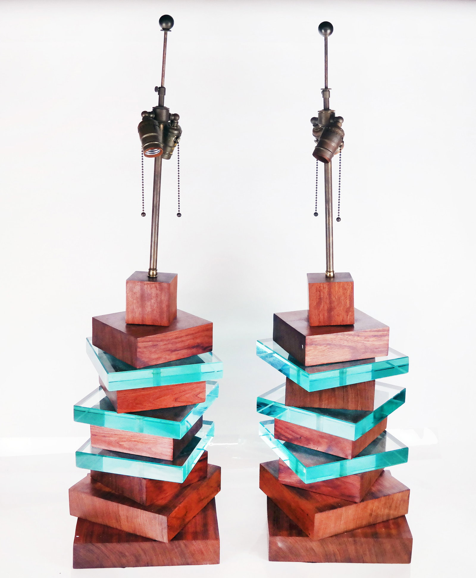 Pair of Modernist Lamps: Pair of Modernist teak and glass lamps, comprised of stacking adjustable blocks in skyscraper form. Provenance: From the Collection of renowned architect and designer Thierry Despont. [36" H x 9 3/4" 