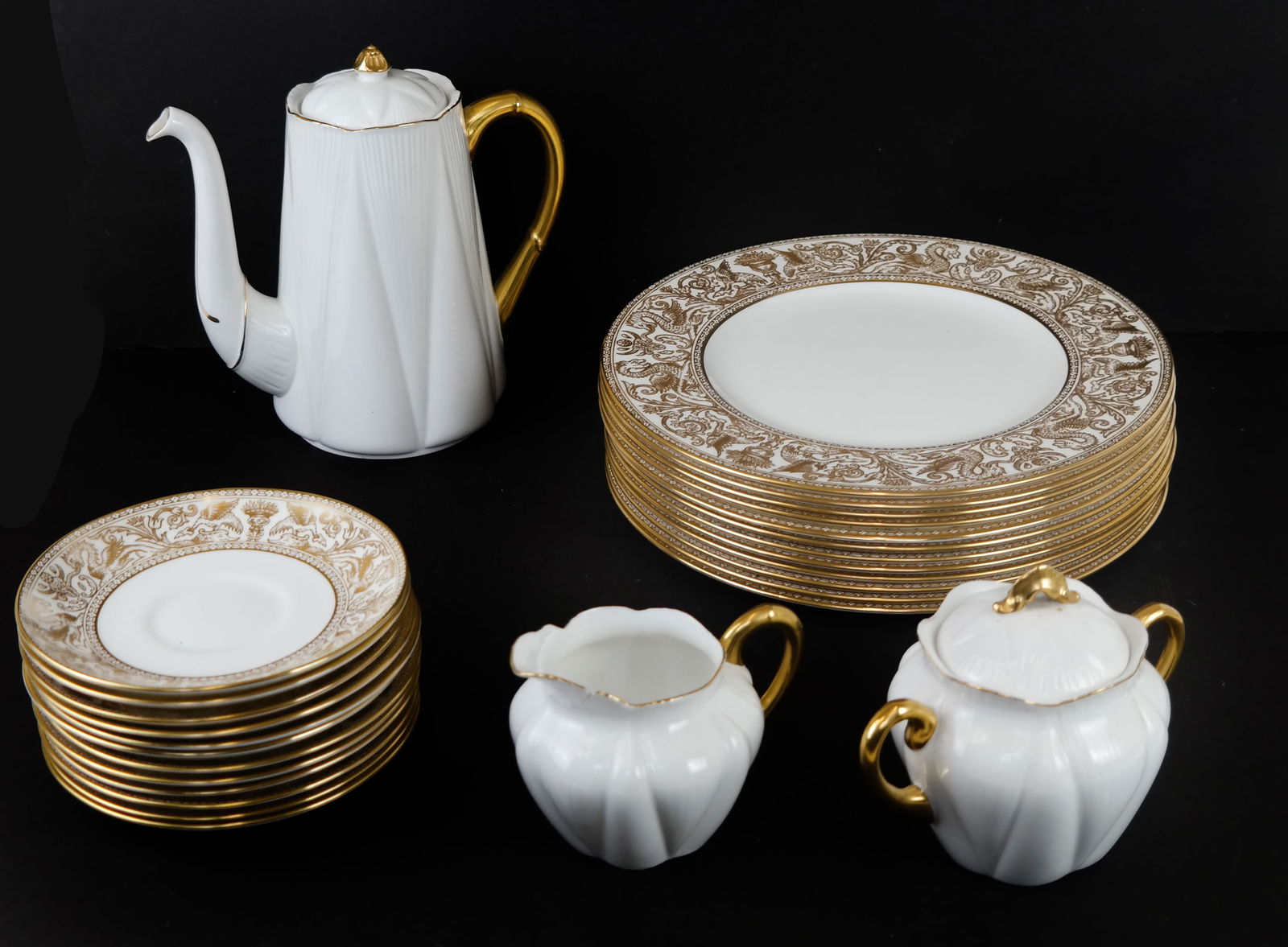 Wedgwood Florentine Gold Partial Service (27): Wedgwood 20th century "Florentine" gold partial service, comprising 12 dinner plates (10 5/8" Diam.], and 12 saucers, together with Shelley English coffee pot, creamer and sugar [8" H]. Condition repo
