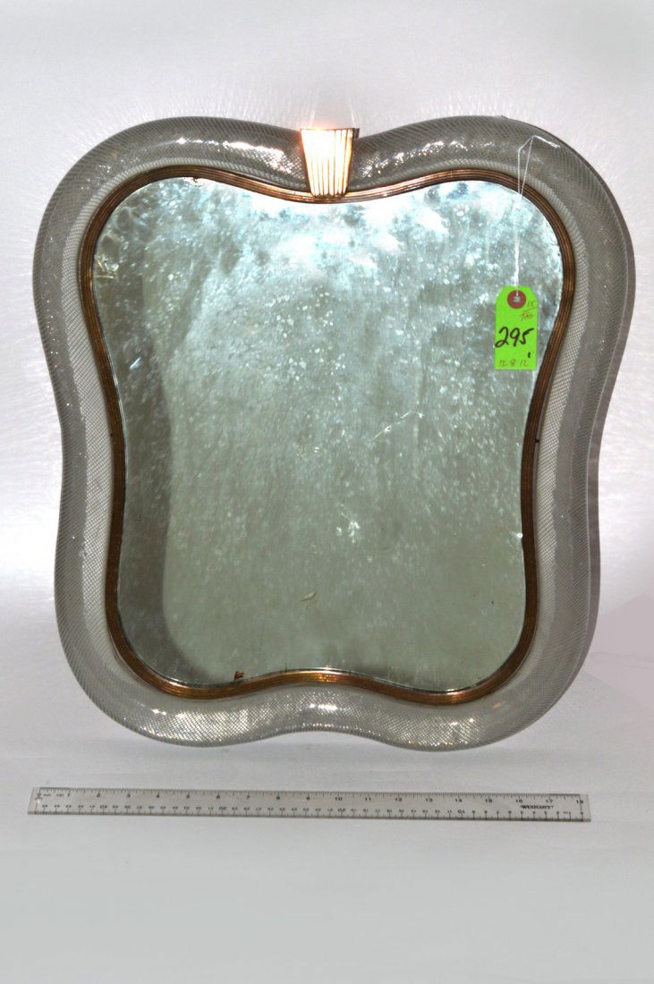 Venini Glass Mirror: Cartouche form decorated glass mirror. Deco-style metal center frame. Back of stand marked "Venini Murano." Overall good. 21 1/2" x 19".