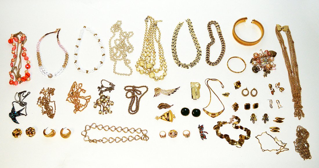 Assorted Gold-Tone Costume Jewelry: Comprises of necklaces, bracelets, earrings, pins, pendants and a choker. Includes jade, faux pearl, and colored paste stones. Approximately 40 items.