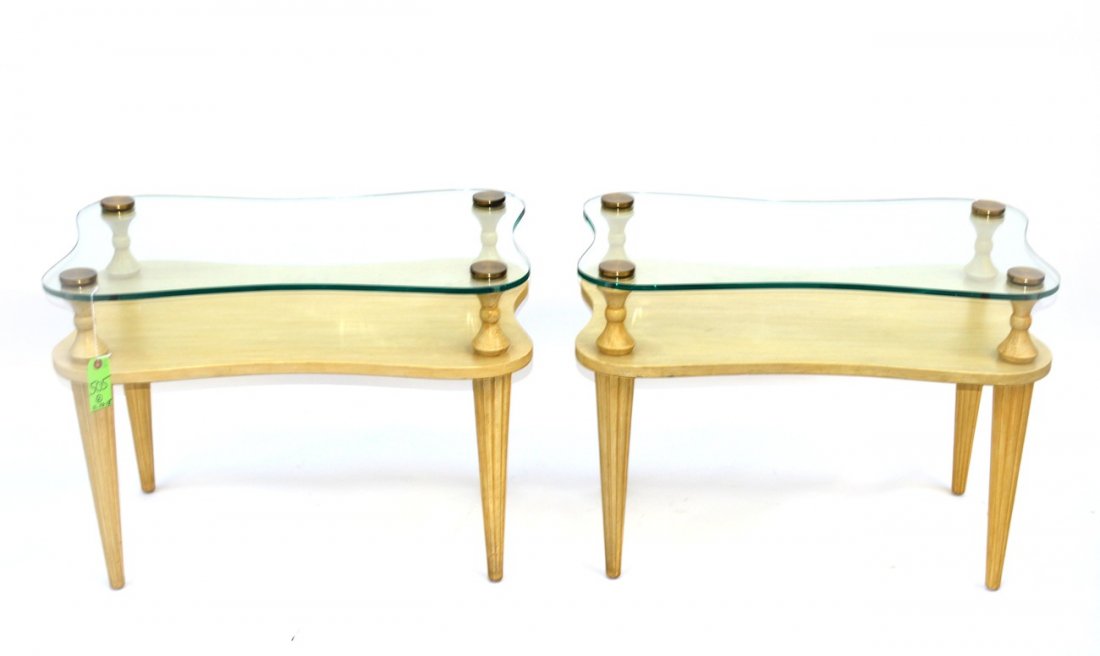 Pair of Gilbert Rohde End Tables: Pair of bi-level wooden end table by Gilbert Rohde with tapered legs with brass hardware and glass legs. circa 1940. Wear to metal finish and minor losses. 21.5"W x 17.75" x 21"H.