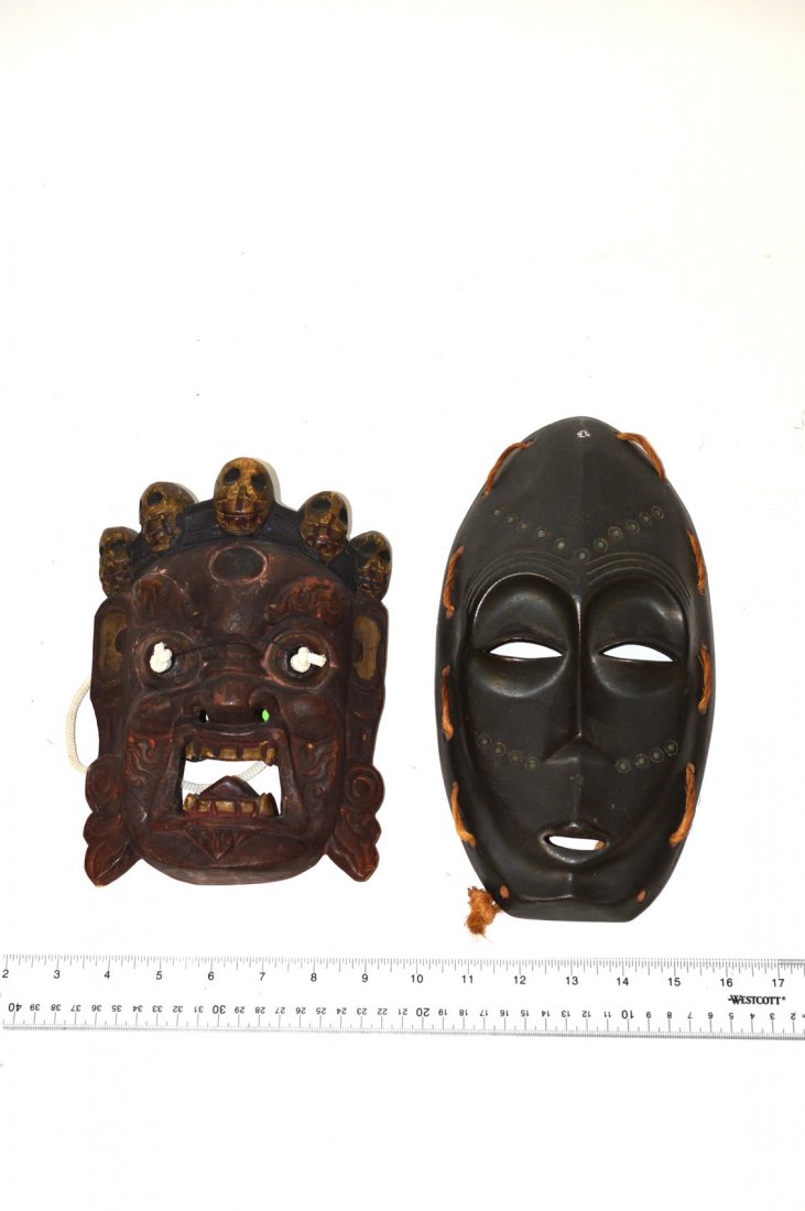 Two Masks: One black, the other red with skulls. Some losses. 11 1/4" [tallest]