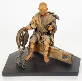 Sculpture of a Man with Spinning Wheel