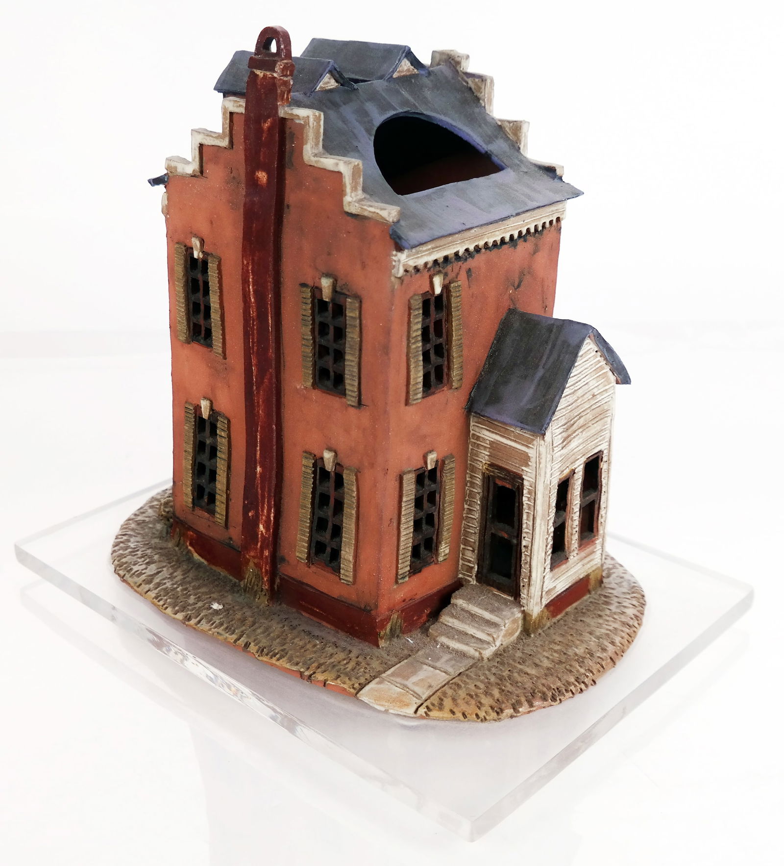 Ceramic Sculpture of a House: Ceramic sculpture of a house on a lucite base. No apparent signature. Provenance: From the Collection of Brendelle & Fred Walden. [Overall including base: 9 1/2" H x 8" W x 11" D]. Overall good condit