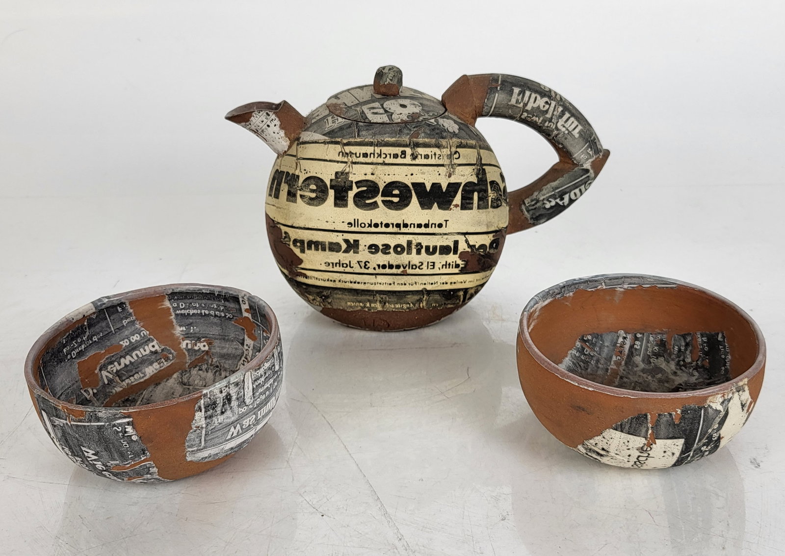 Three Decoupage Pottery Vessels: Three decoupage pottery vessels, including two bowls and a teapot. Provenance: From the Collection of Brendelle & Fred Walden. [Teapot: 4 1/2" H x 6 1/2" W; Bowls: 2" H x 3 1/2" Diam.]. Overall good c