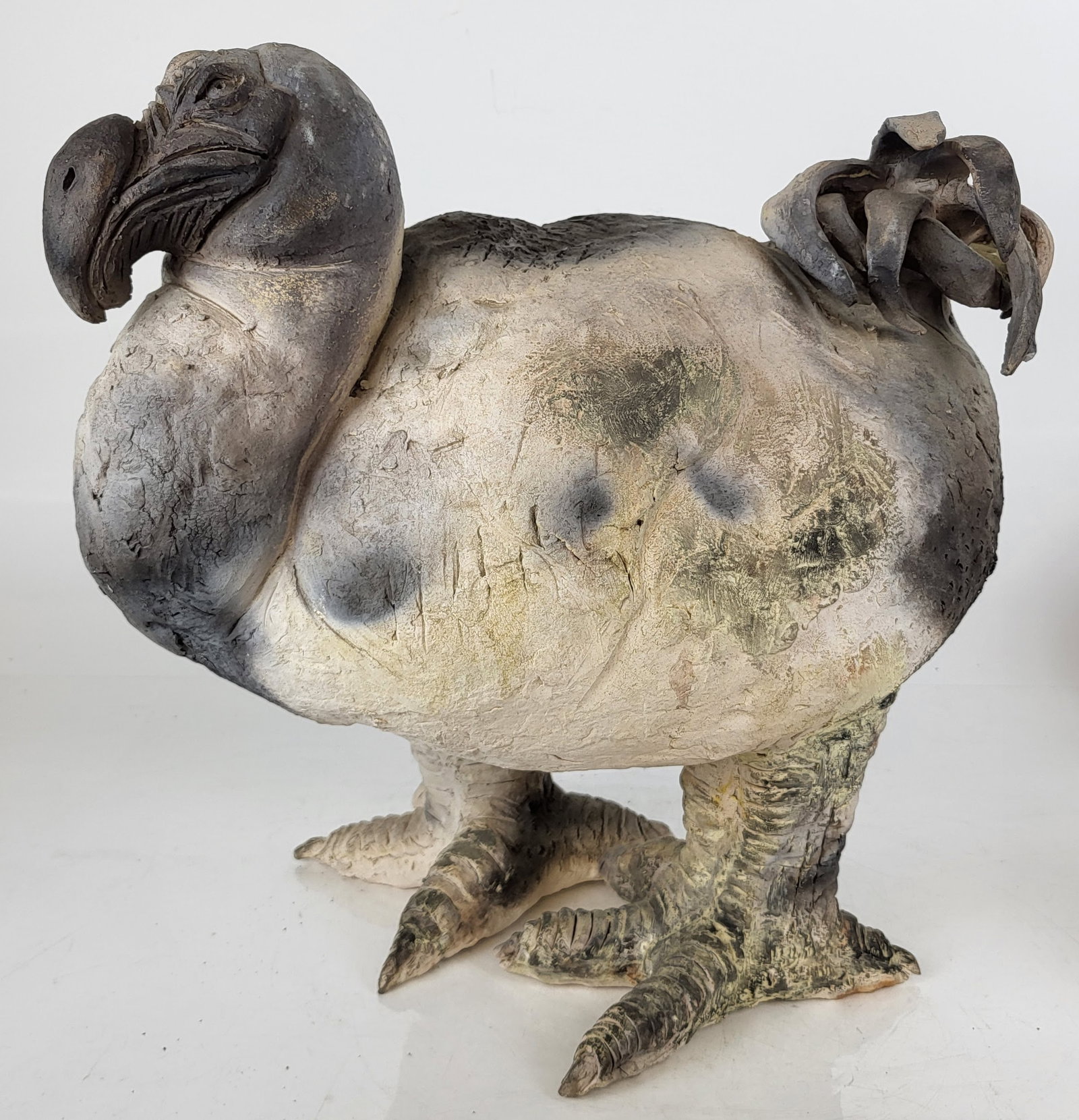 Ceramic Sculpture of a Dodo Bird on Iron Plinth: Ceramic sculpture of a dodo bird supported by a low iron plinth. No apparent signature. Provenance: From the Collection of Brendelle & Fred Walden. [17" H x 17" W x 11" D]. Overall good condition.