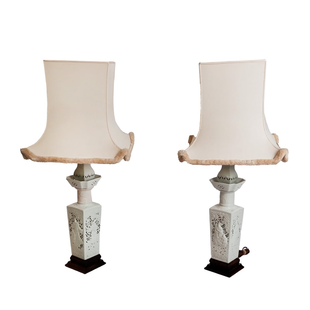Pair of Blanc de Chine Vase Lamps: Pair of 20th century Chinese blanc de chine squared, pierced vases decorated with figures in landscapes, mounted as lamps on wood bases with pagoda-shaped shades. [37 1/2" H to glass shade]. Condition