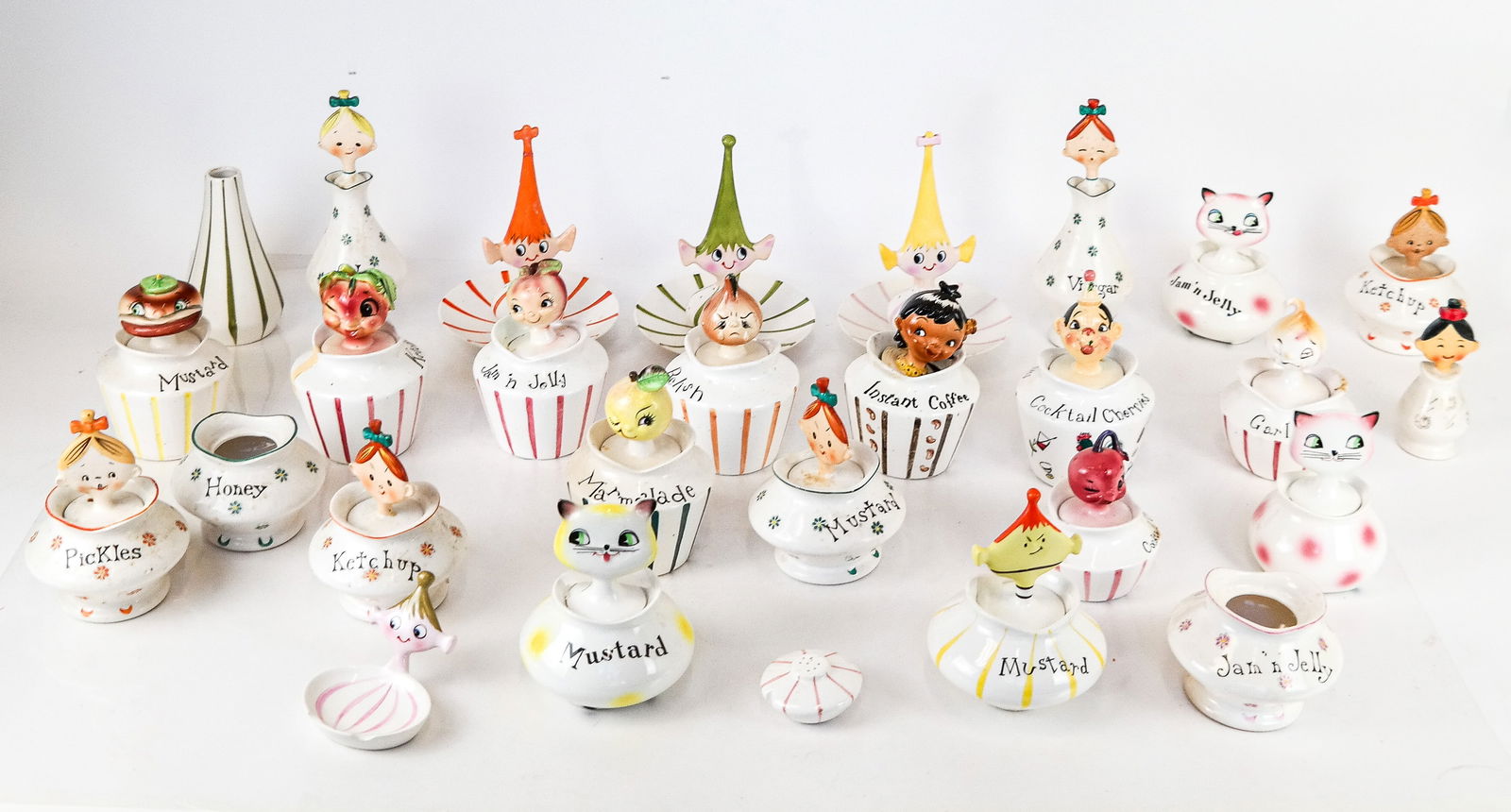 Large Group of Holt Howard and ESD Porcelain: Holt Howard (Japan) and ESD (Japan) porcelain containers and serveware, including 26 containers, one vinegar bottle, 3 hors d'eouvres plates, 6 shakers and one ashtray. [Largest: 8 1/2" H x 6" Diam.].