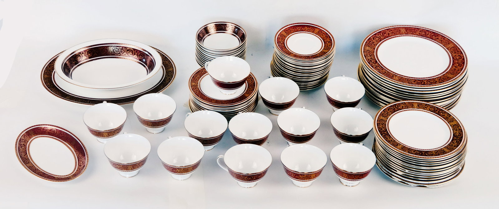 Royal Doulton "Buckingham" Part Dinner Service (90): Royal Doulton "Buckingham" part dinner service, the wide border of crimson accented with scrolling gilt decoration; comprising fourteen dinner plates [10.5" Diameter], fourteen luncheon plates, fourte
