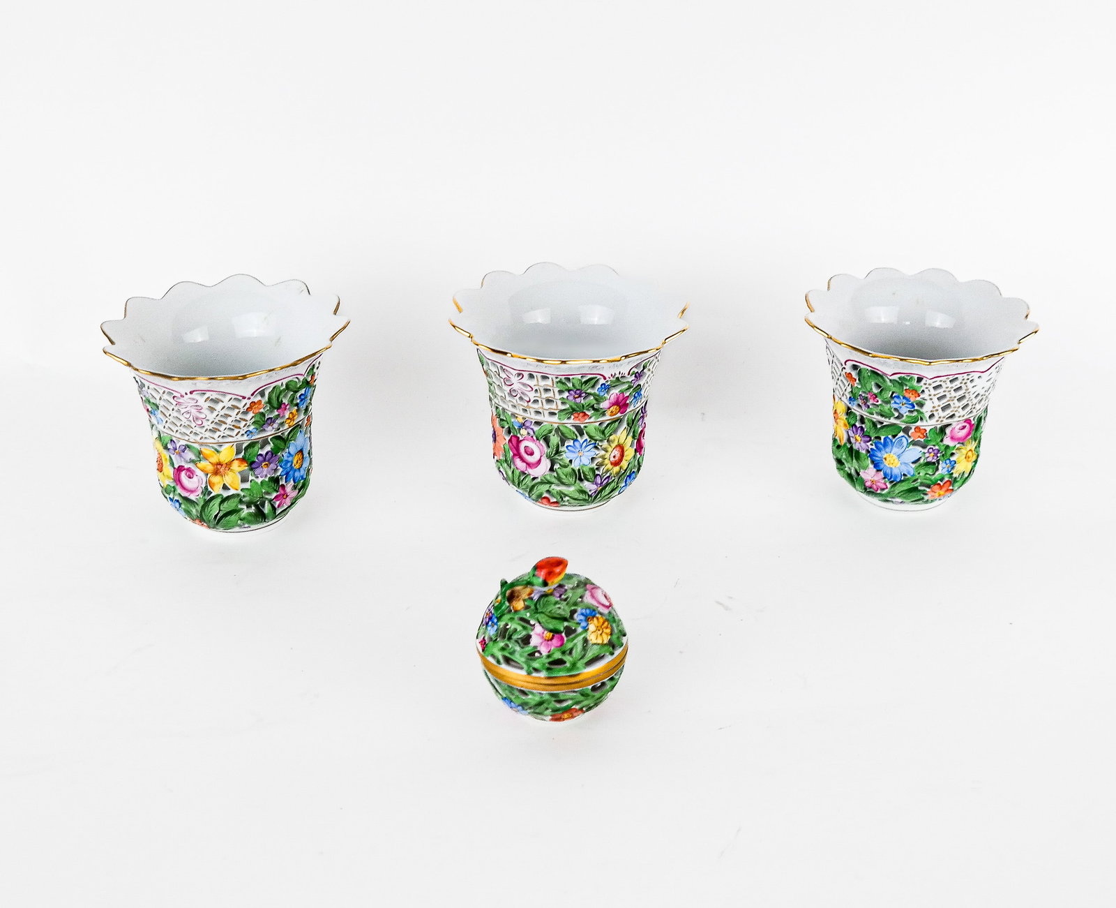 Herend Set of Cachepots and Potpourri Bowl (4): Herend set of three handpainted reticulated and pierced floral decorated cachepots [5" H x 5.5" Diameter], and a potpourri bowl; marks to base. Property of an important NY philanthropic family. Condit