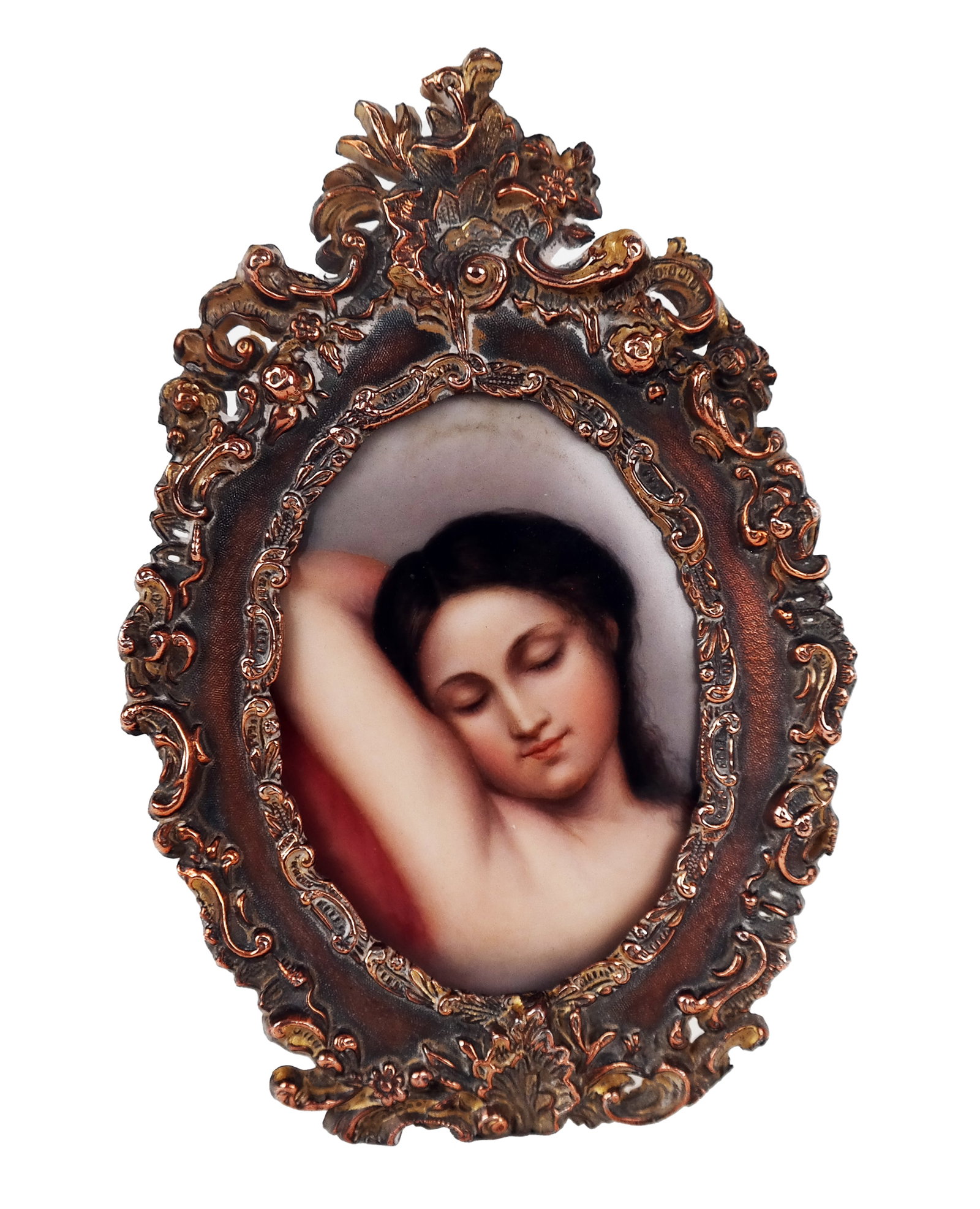 Bronze Framed Oval Porcelain Plaque: A bronze ornately framed oval porcelain plaque depicting a semi nude woman asleep on a pillow, probably German. Paper label to reverse. [Plaque: 3.5" H x 2.75" W; Overall: 5.75" H x 3.75" W]. Property