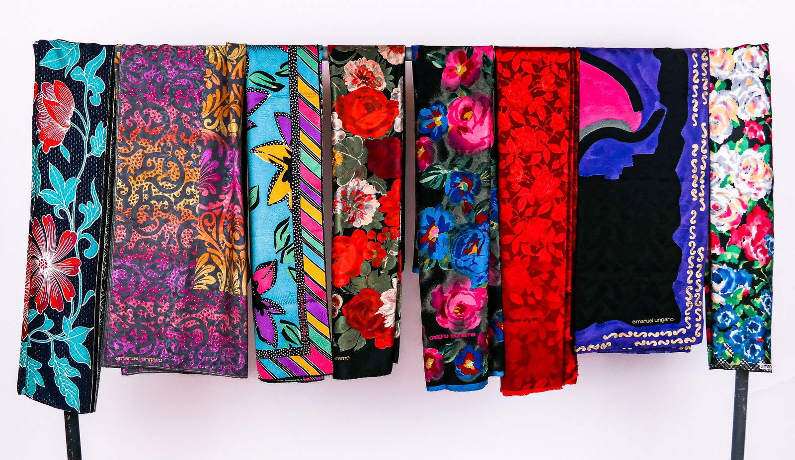 Emanuel Ungaro Vintage Large Silk Scarves (8): Eight Emanuel Ungaro vintage silk jacquard scarves including gray scarf with ombre damask print in purple, yellow and orange; black scarf with purple and gold decorated border; polychrome floral decor