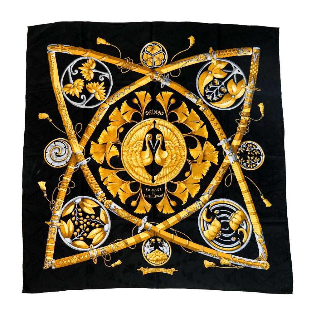 Hermes Silk "Daimyo" Scarf: Hermes silk jacquard "Daimyo" scarf by Francoise Faconnet in black ginko printed jacquard with gold design; signed on the scarf with hand rolled hem. [34" Square]. Overall condition is good. Property