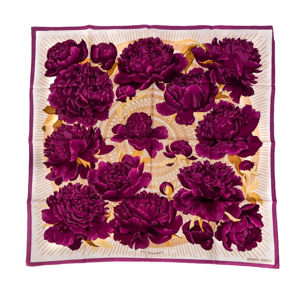 Hermes Silk "Les Pivoines" Scarf: Hermes silk "Les Pivoines" scarf designed by Christiane Vauzelles in 1976 in cream with purple peony design and border; signed on the scarf with hand rolled hem. [34" square]. Overall condition is goo