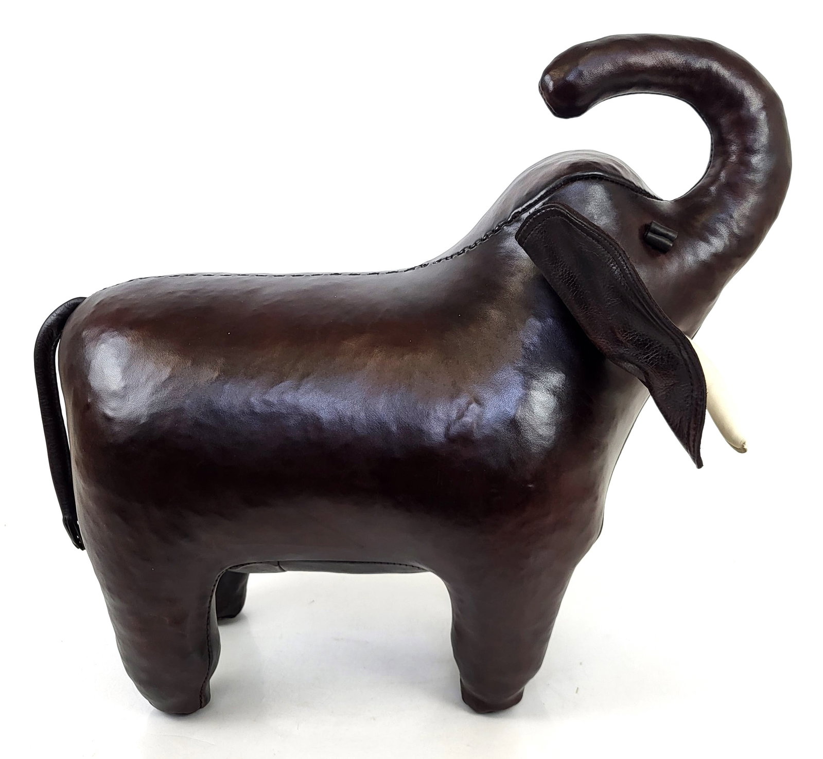 Decorative Leather Elephant: Decorative leather elephant, late 20th century, with metal-capped feet. [19" H x 22" W x 15" D]. In very good condition. Condition reports and requests for additional photos cannot be accepted on this