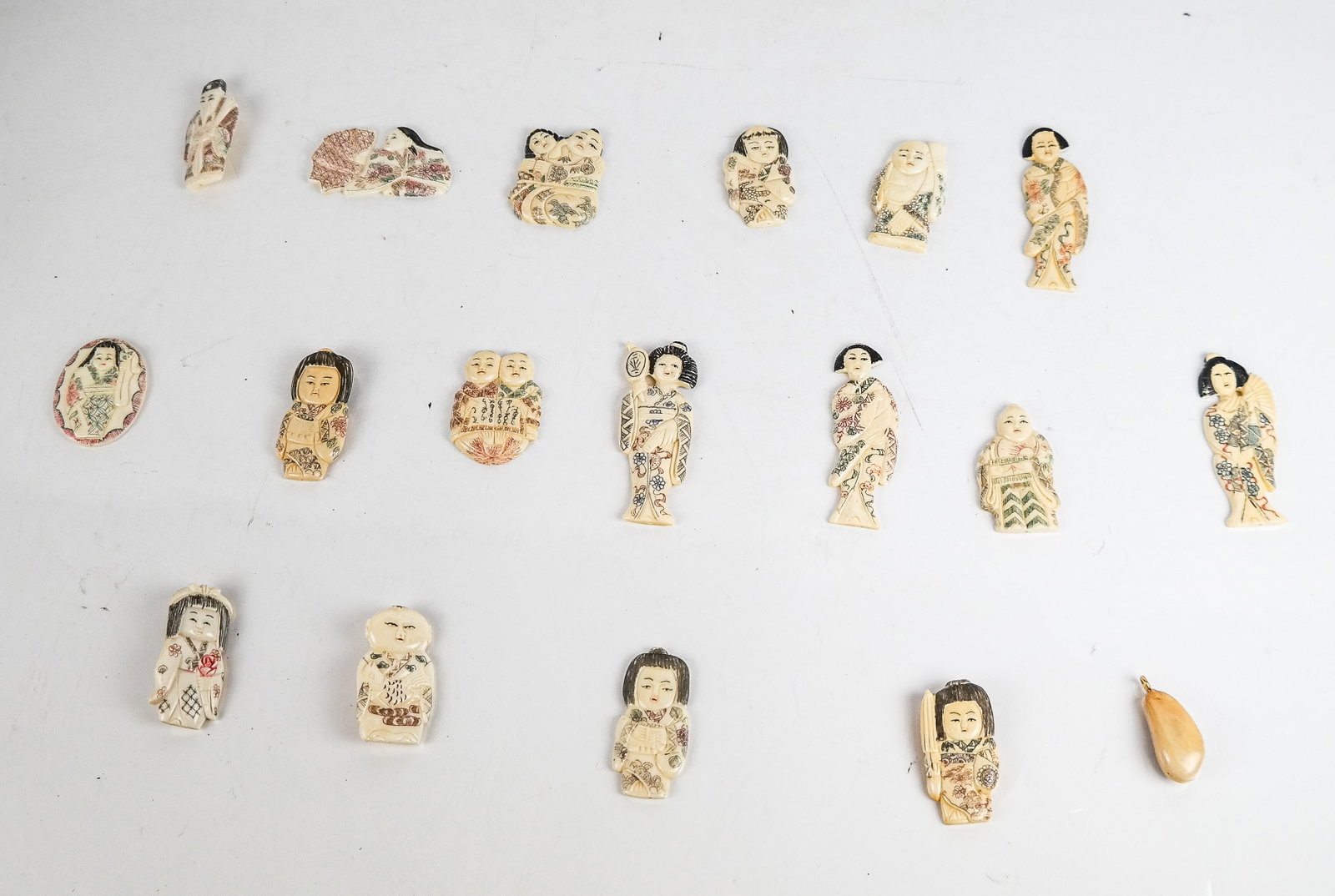 Group of Polychrome Bone Items (18): Group of polychrome decorated bone brooches, pendant and accessories in the Japanese taste, comprising 12 accessories, 1 pendant, and 5 brooches.