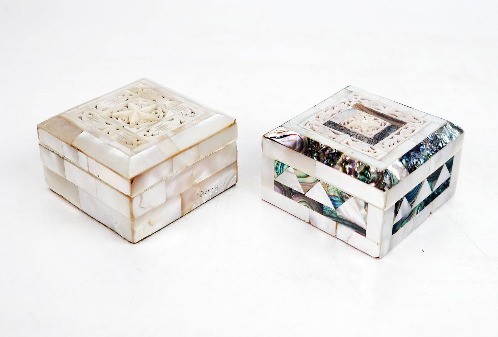 Two Mother-of-Pearl Boxes: Two 20th century English hand-carved mother-of-pearl and abalone boxes with fabric lining. [1 3/4" H x 2 3/4" W x 2 3/4" D]. In good condition, with no losses to pearl. Condition reports and requests 
