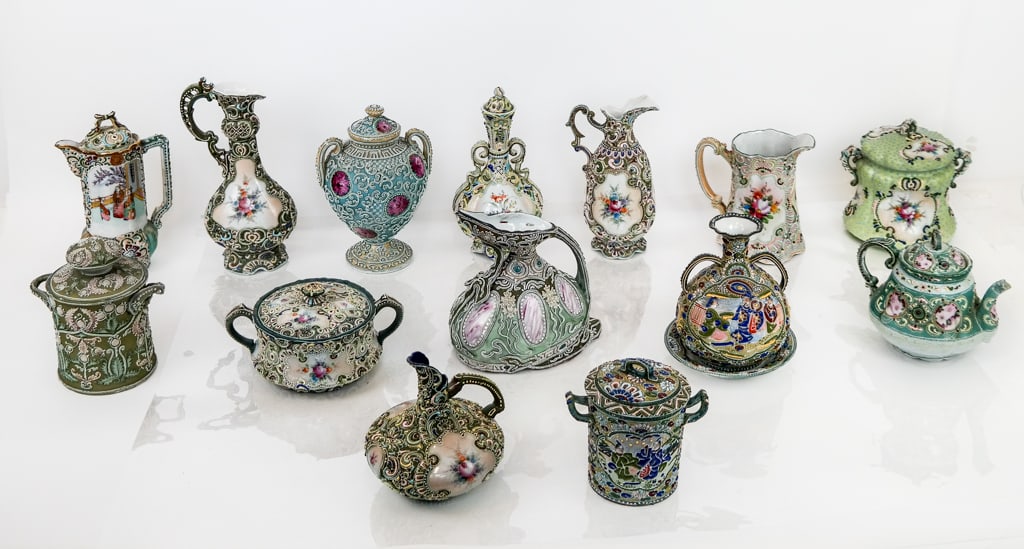 Japanese Moriage Painted Nipponware Porcelain, 15: 15 Japanese Moriage painted porcelain articles, 20th century, including one pitcher, four ewers, one saucer, two urns, three jars, one humidor, two teapots, and one vase. Tallest: 10.5" H x 5" W x 4" 