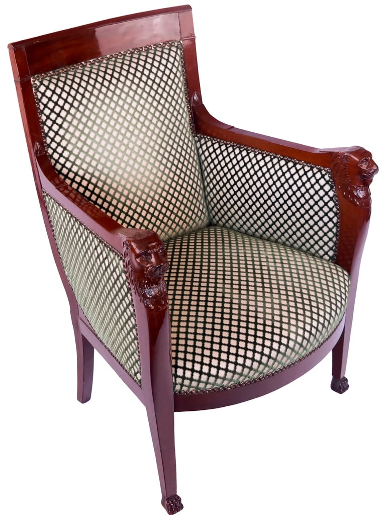 Empire Period Mahogany Upholstered Bergere: An Empire period mahogany bergere having ornately carved lions head and mane on paw feet with cut velvet upholstery. Upholstery en suite with previous chair. [39" H x 28" W x 21" D]. Property of an im