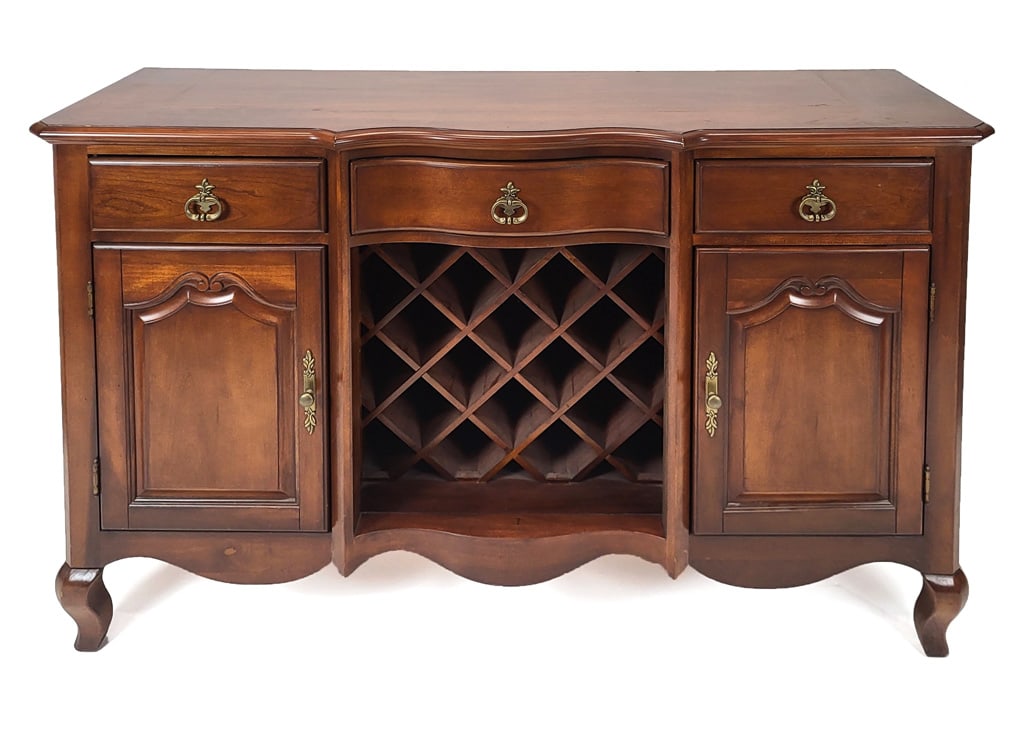 Country French Dining Server: Country French-style two-door server with center opening wine rack, all below three drawers and serpentine top. [38" H x 60" W x 19" D]. Condition reports and requests for additional photos cannot be