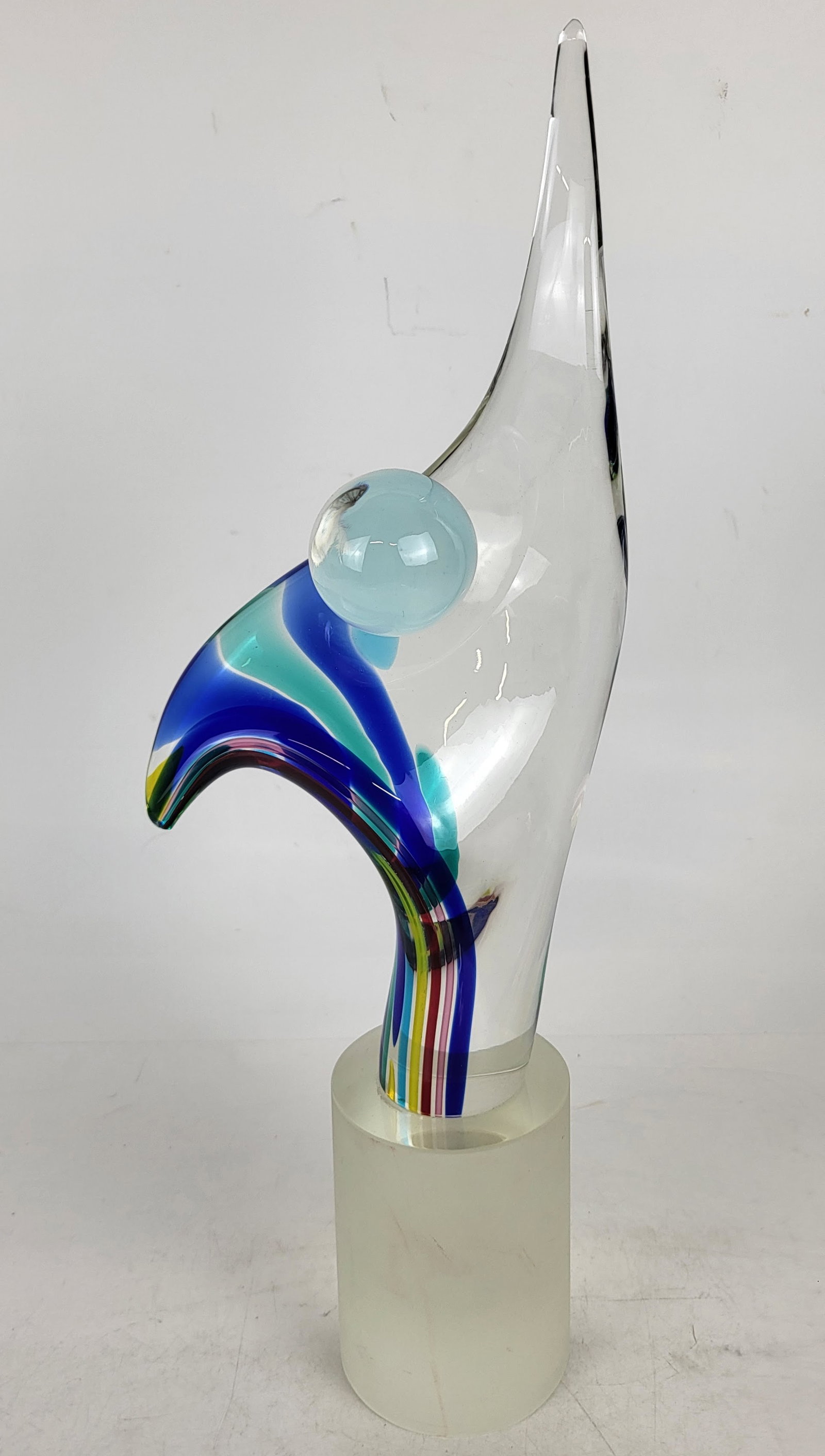 Murano Glass Sculpture: Murano glass sculpture on an attached frosted glass base, signed by the artist at base. [19" H x 6" W x 4 1/2" D]. In overall good condition, with no chips.