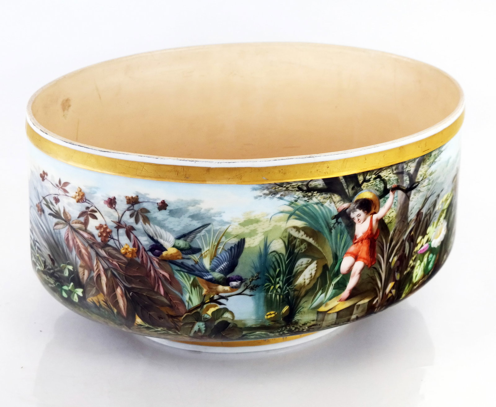 French Oval Porcelain Decorated Jardiniere: Late 19th century porcelain oval planter/bowl with decoration of wildlife, landscape and a cherub. [8" H x 14" W x 9 1/2" D]. Worn rim; age cracks. Condition reports and requests for additional photos