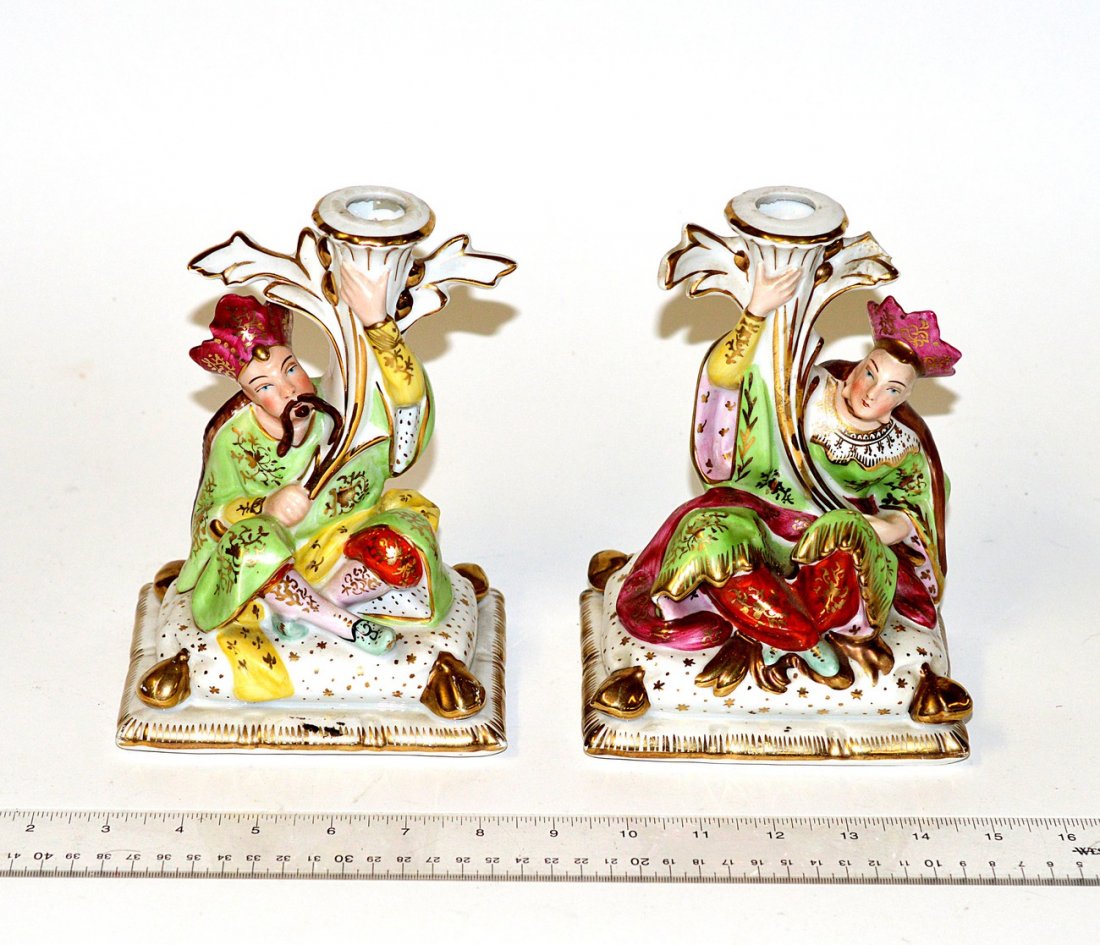 Pair of Orientalist Porcelain Candlesticks: Pair of figural candlesticks, decorated man and woman. 7 1/2" x 4" x 5".