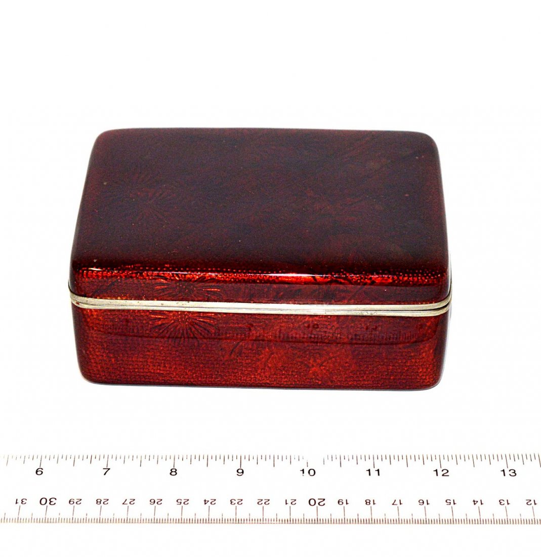 Enamel and Silvered Box: Ruby red floral decorated hinged box. 4" x 5 1/2" x 2 1/4" H.