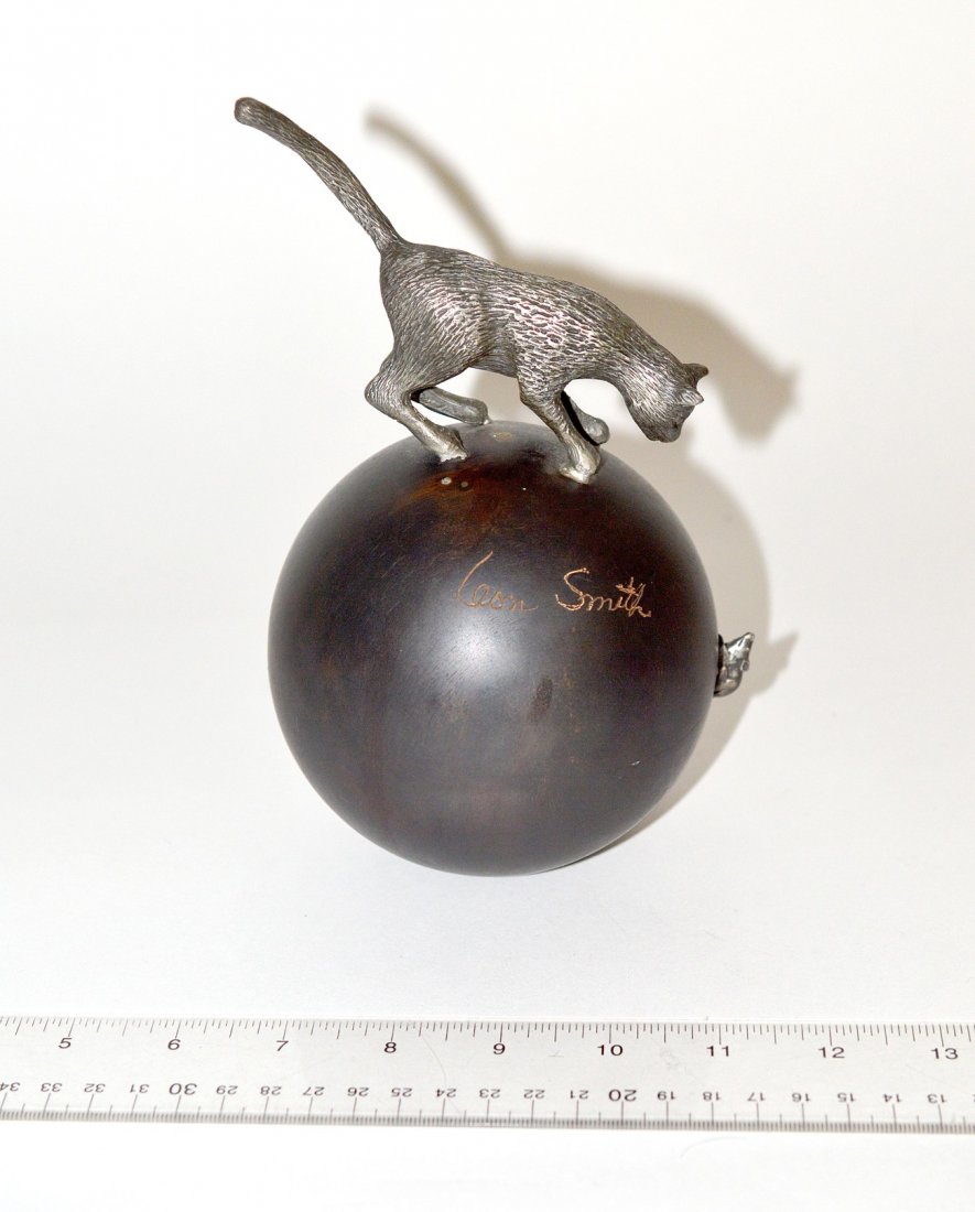 Leon Smith, "Cat and Mouse": A bronze pendulum sculpture of a cat chasing a mouse. Signed "Leon Smith." 4" Dia. x 8"H. In good condition.