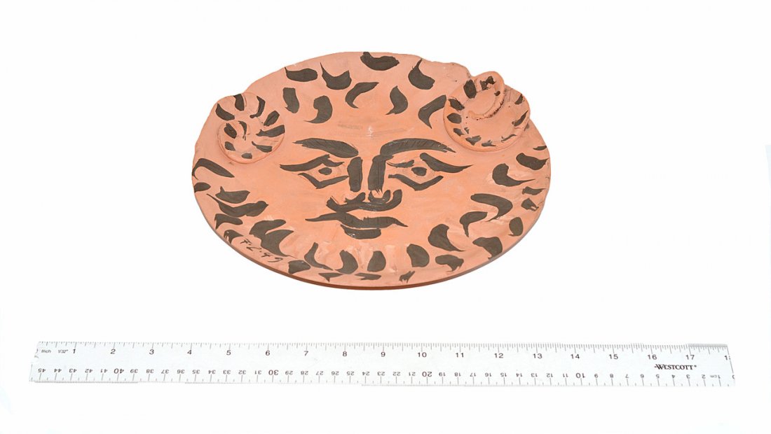 After Picasso - Terracotta "Centaur" Plate: Unglazed painted plate with face at center and low relief scrolling horns at top. Inscribed at bottom left "7-2-49". Bottom bears a small centaur head above an inscription. "Edition Picasso 2/2 Madour