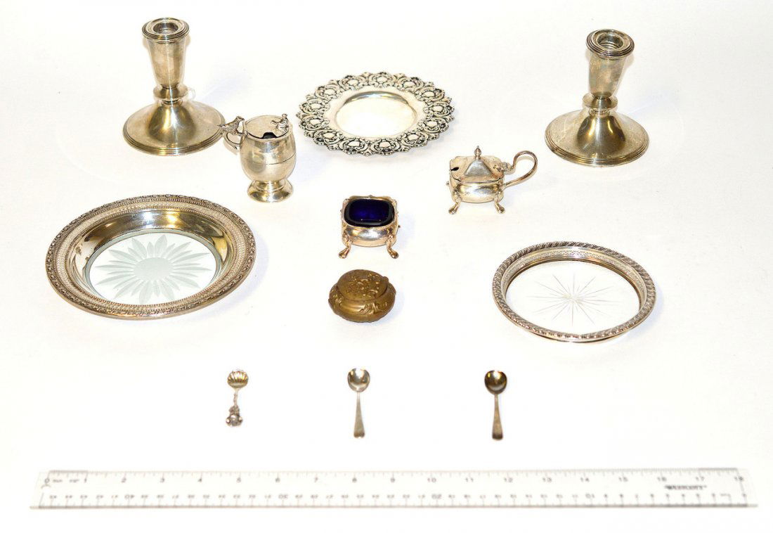 Assorted Silver and Plated Articles: Sterling comprises: Pair of weighted candle sticks, 2 wine coasters with etched glass centers, glass lined condiment with spoon, ladle, and repousse dish. Weighable 4.37 ozt. Accompanied by two blue g