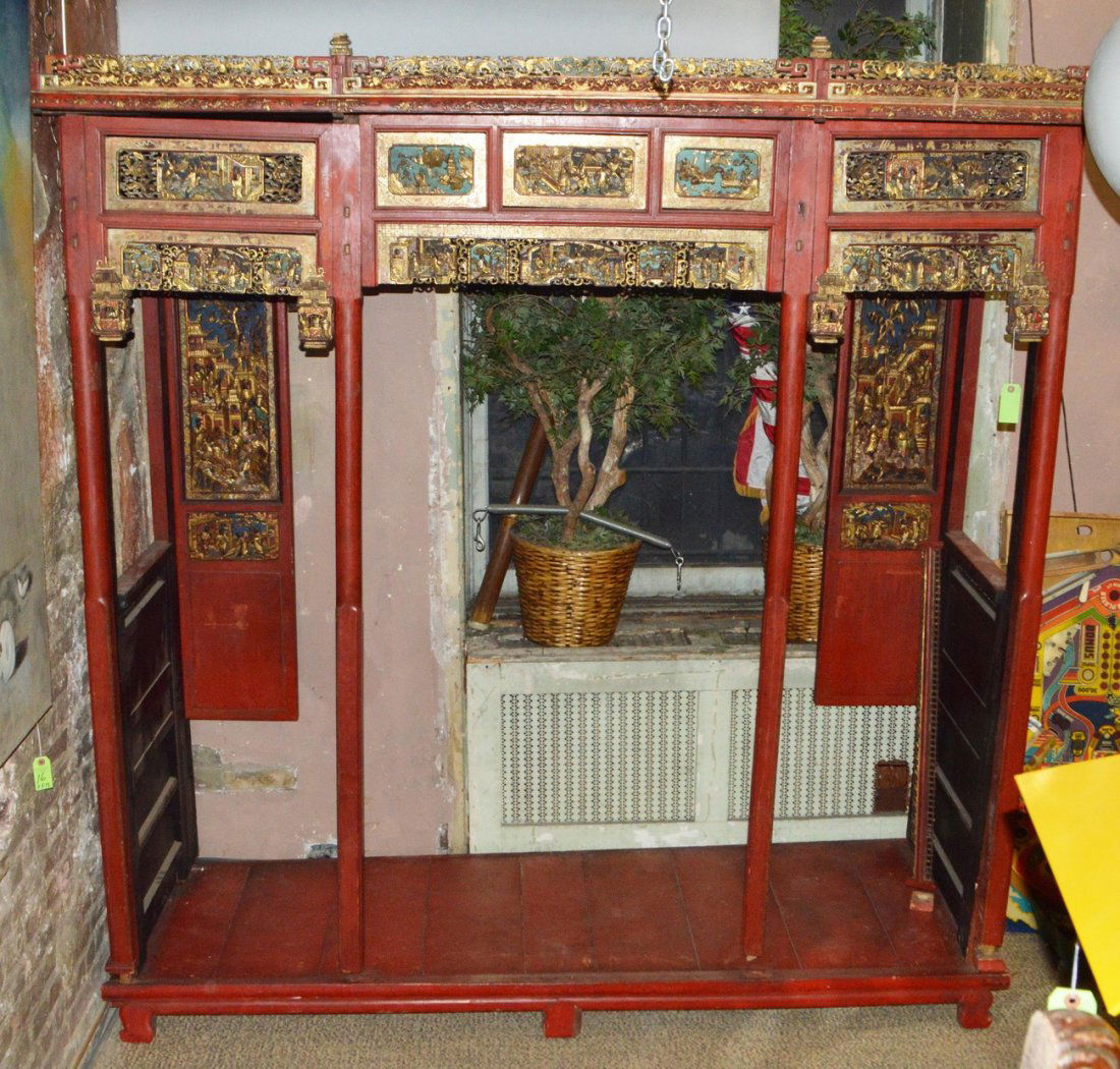 Opium Bed: Red painted opium bed with gilt carved scenic panels. 90" L x 32" D x 96" H. (approx). Mostly intact.