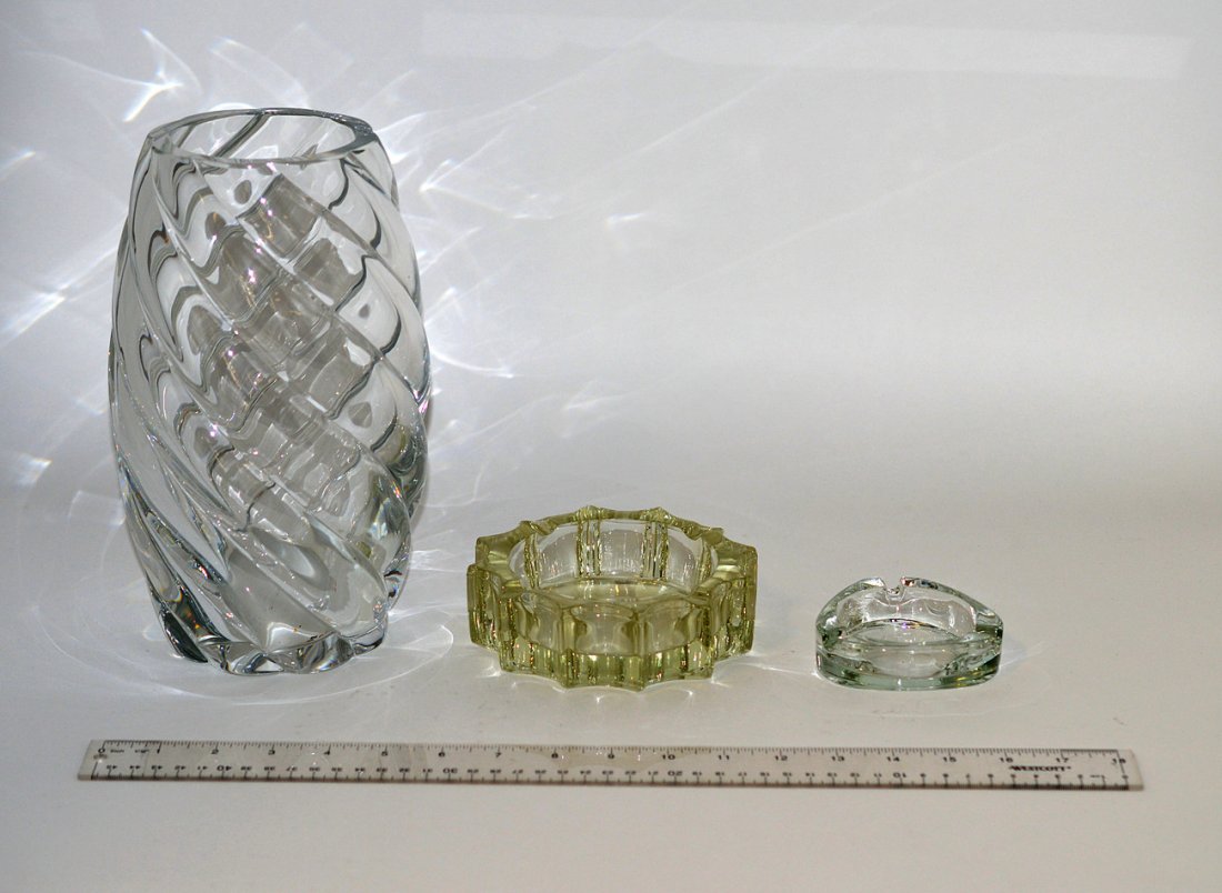 Baccarat Crystal Vase and Others: Clear crystal vase with vertical twist design. 5 3/4" dia. x 10"H. In good condition. Accompanied by two vintage glass ash receivers.