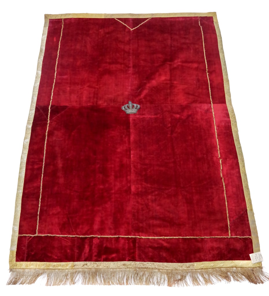 18th/19th C. Silk Velvet Hanging: An 18th/19th C. hanging having joined panels of wine red silk velvet, trimmed with golden looped braid, gold ribbon, and gold fringe, embroidered at the center in silver with a crown, lined in silk. [