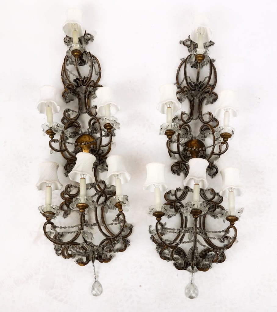 Pair of Bagues Manner Crystal and Glass Sconces: Pair of cut and faceted glass gilt metal six-light sconces in the Bagues manner, 20th century, with swags of beaded crystal [48.5" H x 14.5" W x 10" D]. Overall fair condition with scattered losses to