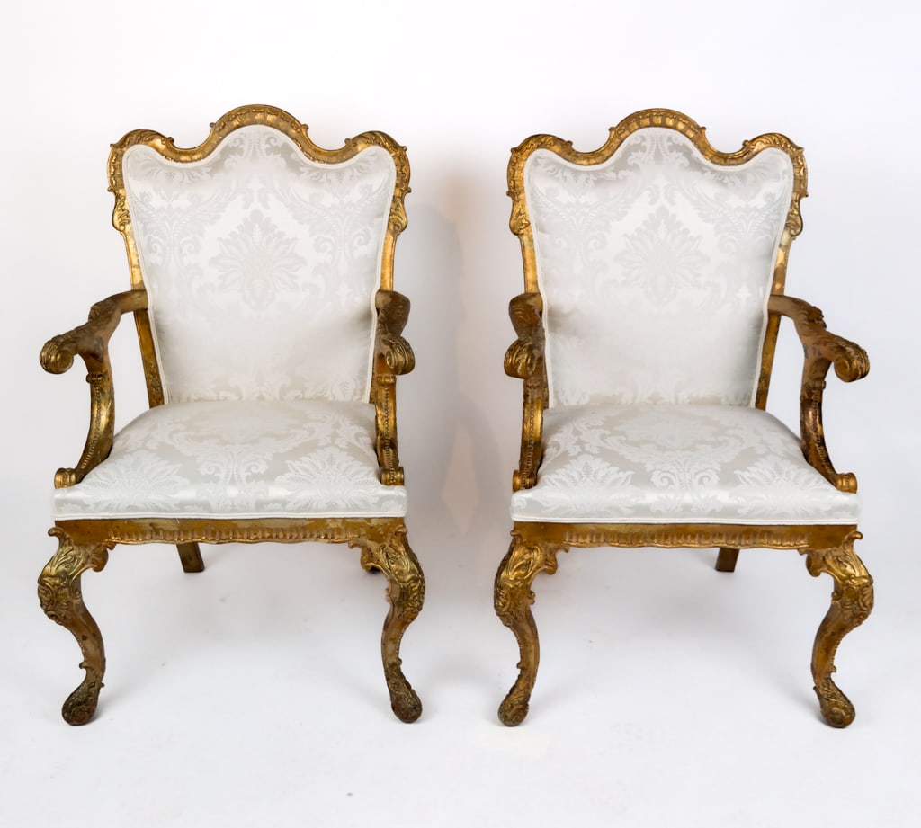 Pair of Venetian Rococo Gilt Wood Armchairs: Pair of Venetian Rococo carved and giltwood upholstered armchairs, 20th Century, with cabriole legs and a scallop top. [41.5" H x 26" W x 24" D; seat height: 19"]. Overall good condition with wear to
