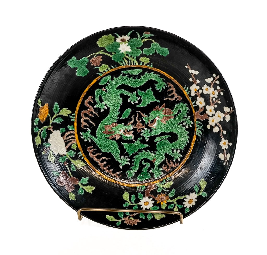 Chinese Qing Dynasty Famille Noir Charger: Chinese Qing Dynasty famille noir three color charger marked "Emperor Kangxi of the Qing Dynasty" at base with sgraffito and color design of two dragons in center and at sides [2.25" H x 10.5" D]. Ove