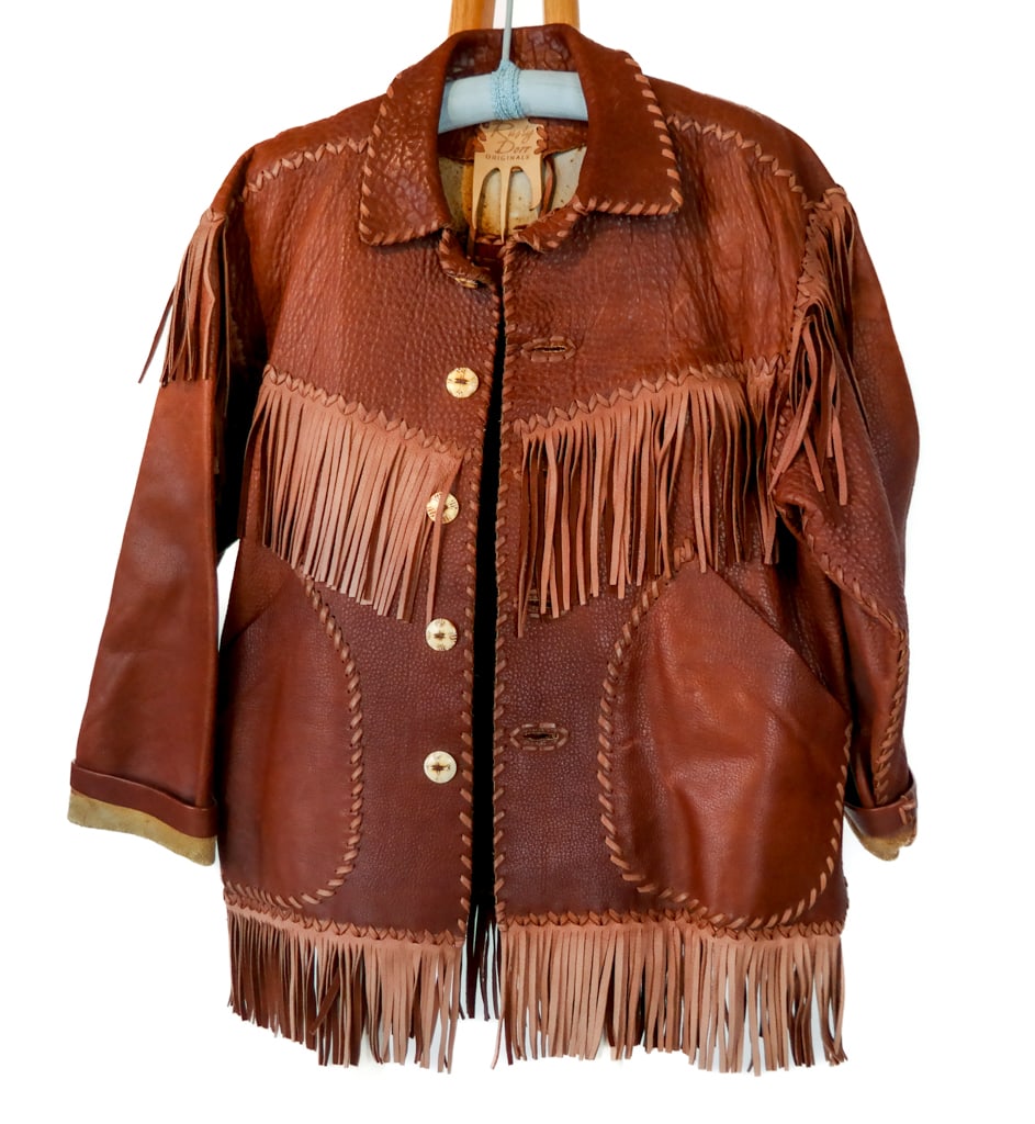RUSTY DORR Leather Fringe Jacket: Rusty Dorr Originals leather men's fringe jacket with two tone details and carved bone buttons. [Size approx. Men's US Large]. Overall good condition with light wear commensurate with age.