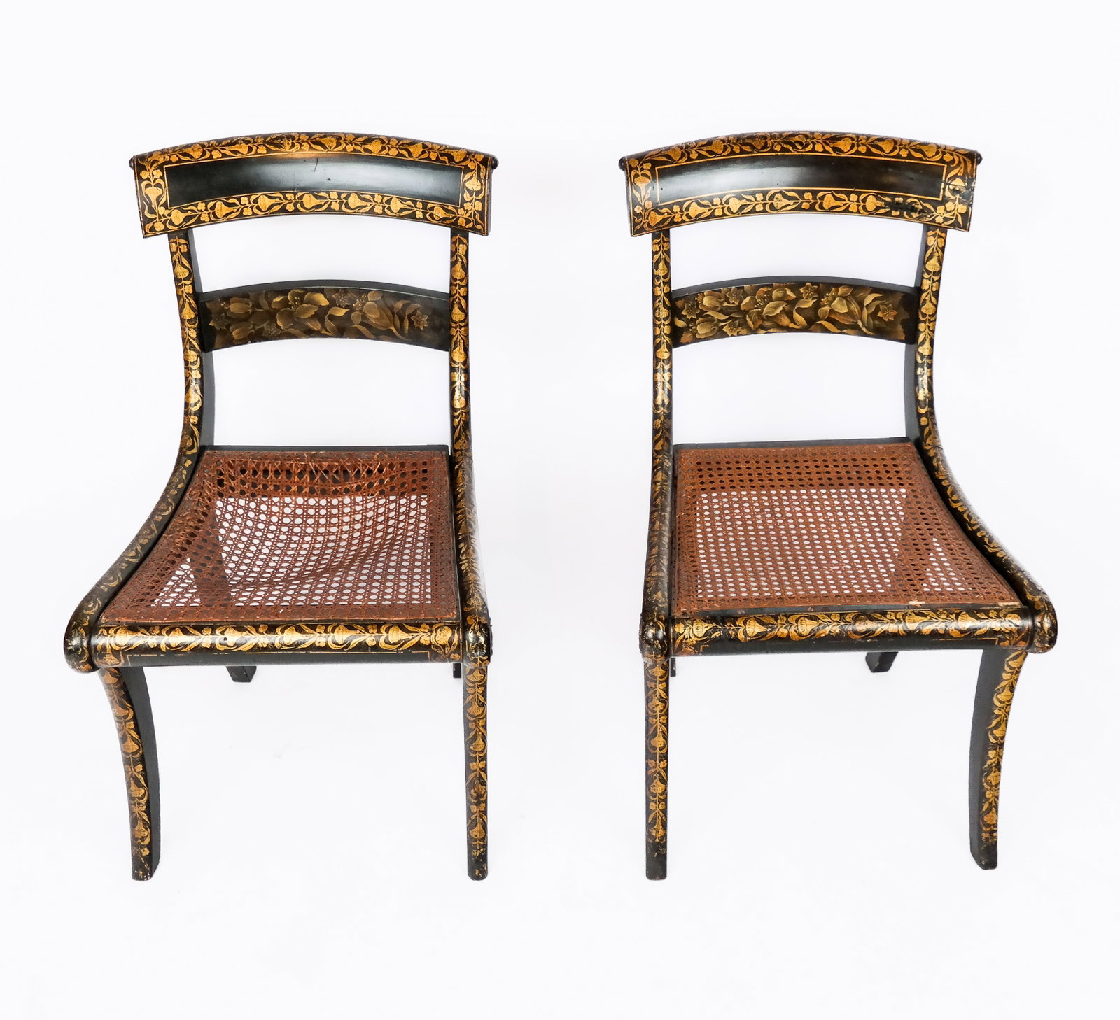 Pair of Federal Caned and Stenciled Chairs: Pair of Federal caned and stenciled chairs, circa 19th century, with gilt painted foliate detail throughout and ebonized wood. [30.25" H x 18" W x 18" D; seat height: 15.5" ]. Overall good condition w
