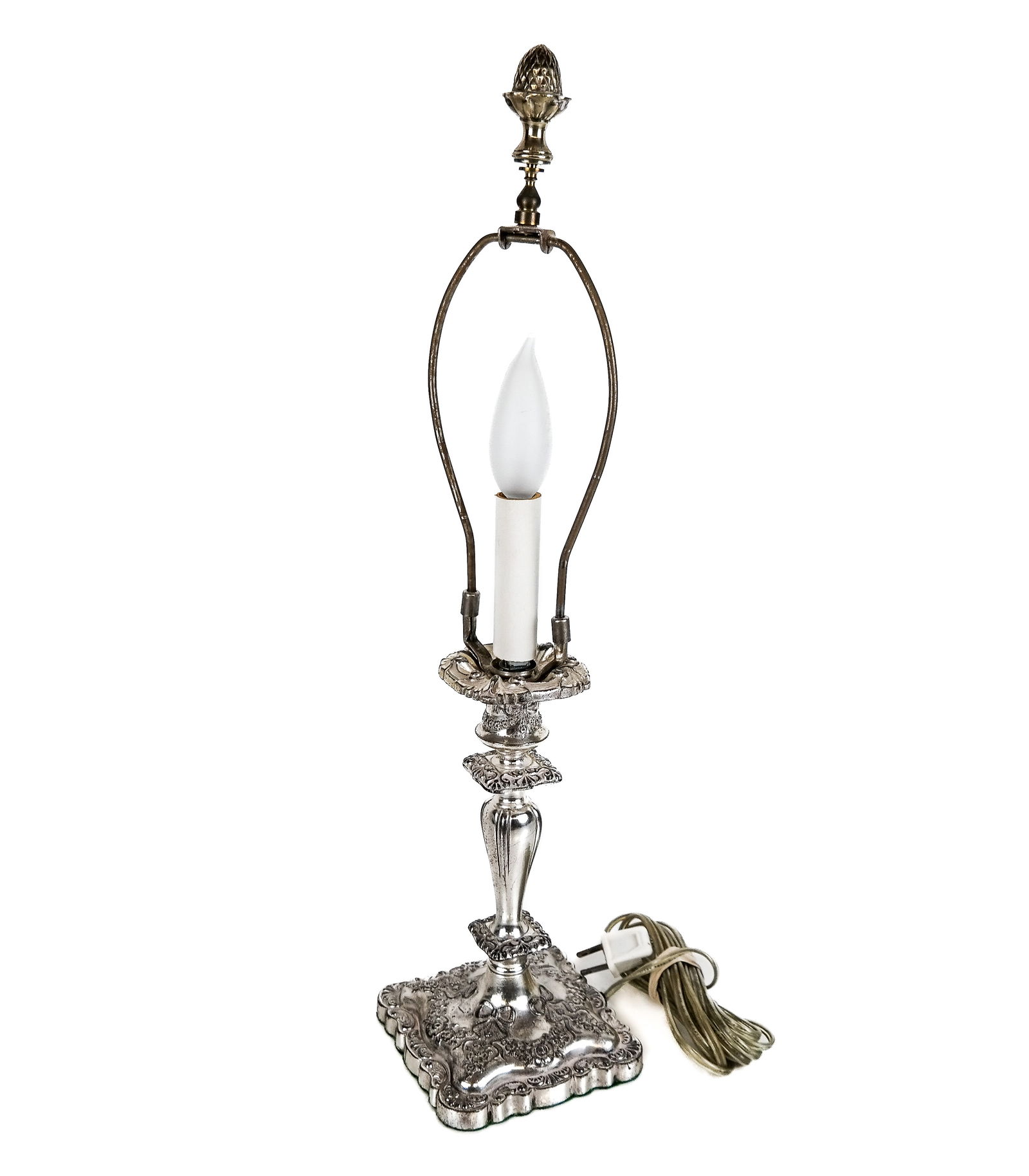 Silvered Metal Candlestick Lamp: Silvered metal candlestick lamp, having ribbon and floral designs with acorn finial, by MB & Co. [21" H x 5" W x 5" D]. Condition reports and requests for additional photos cannot be accepted on this