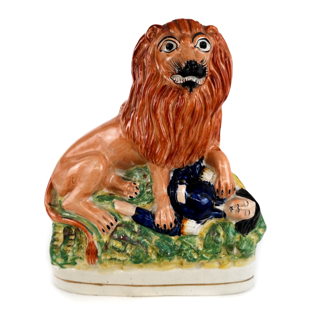 Antique Staffordshire Lion Group: Antique Staffordshire ceramic group depicting a lion over a fallen soldier, retailed by Oliver Sutton Antiques, circa 1860s. [9.5" H x 8" W x 4" D]. Condition reports and requests for additional photo