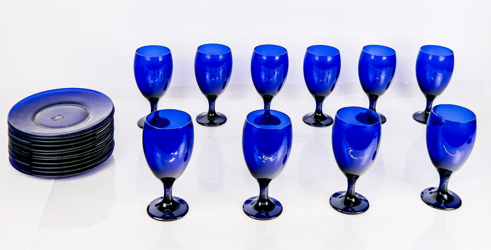 Blue Glass Plates (12) and Stems (10): Twelve 8" plates by Viking and ten unmarked 7" glasses. Condition reports and requests for additional photos cannot be accepted on this lot; please bid accordingly. This is not an indication of good o