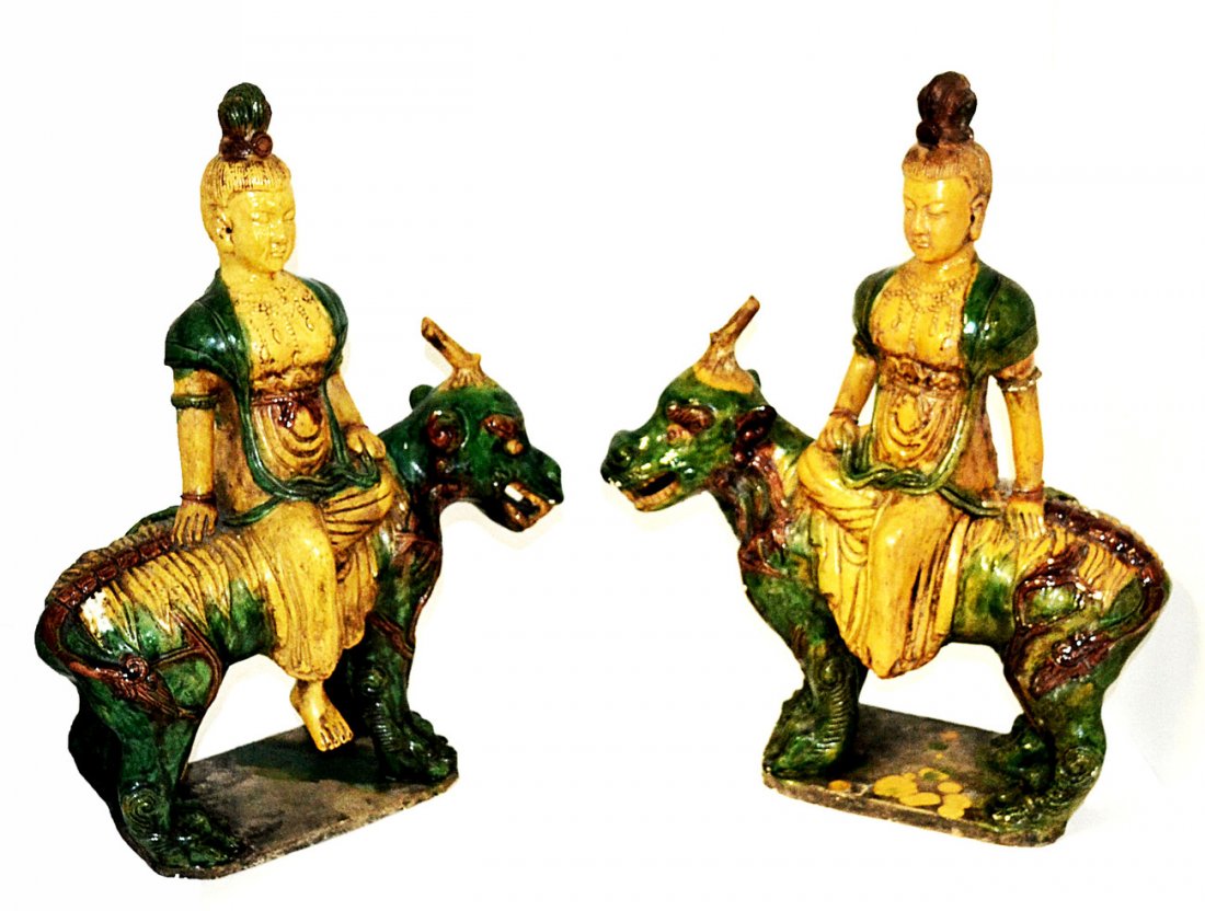 Pr. Of Chinese Glazed Earthenware Figures: Opposing figures depicting noblewomen seated on mythological beasts. One figure missing foot, previous repairs and chips. 17 1/2"W x 8"D x 21 3/4"H.