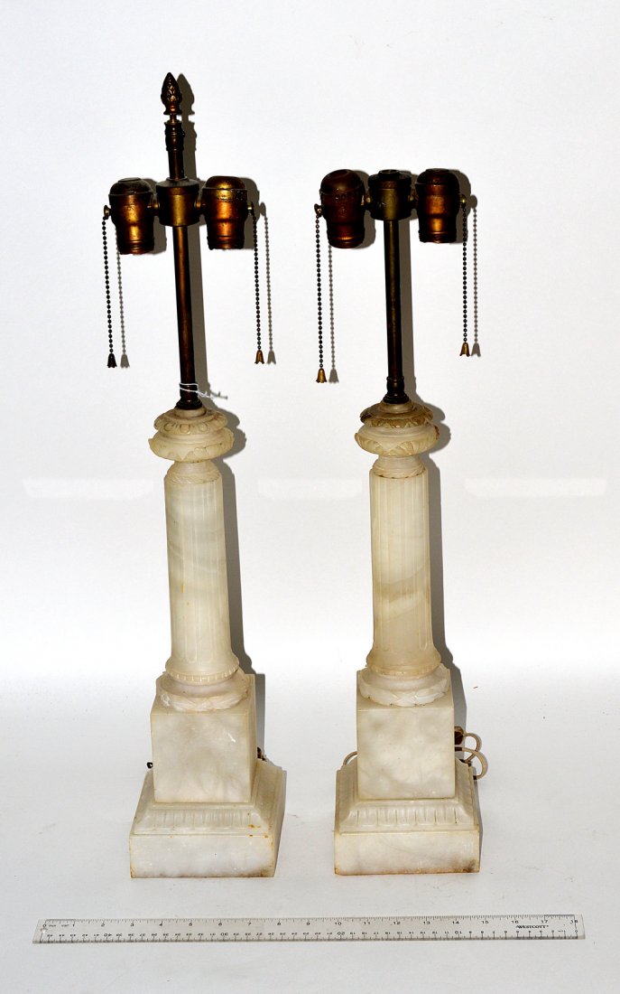 Pair of Alabaster Column-Form Table Lamps: Features fluted columns on a square plinth base and urn-form capitals. 5 1/8" Sq x 24 1/2" H [to top of socket]. One missing finial. Some scuffs and minor chips, otherwise good condition.