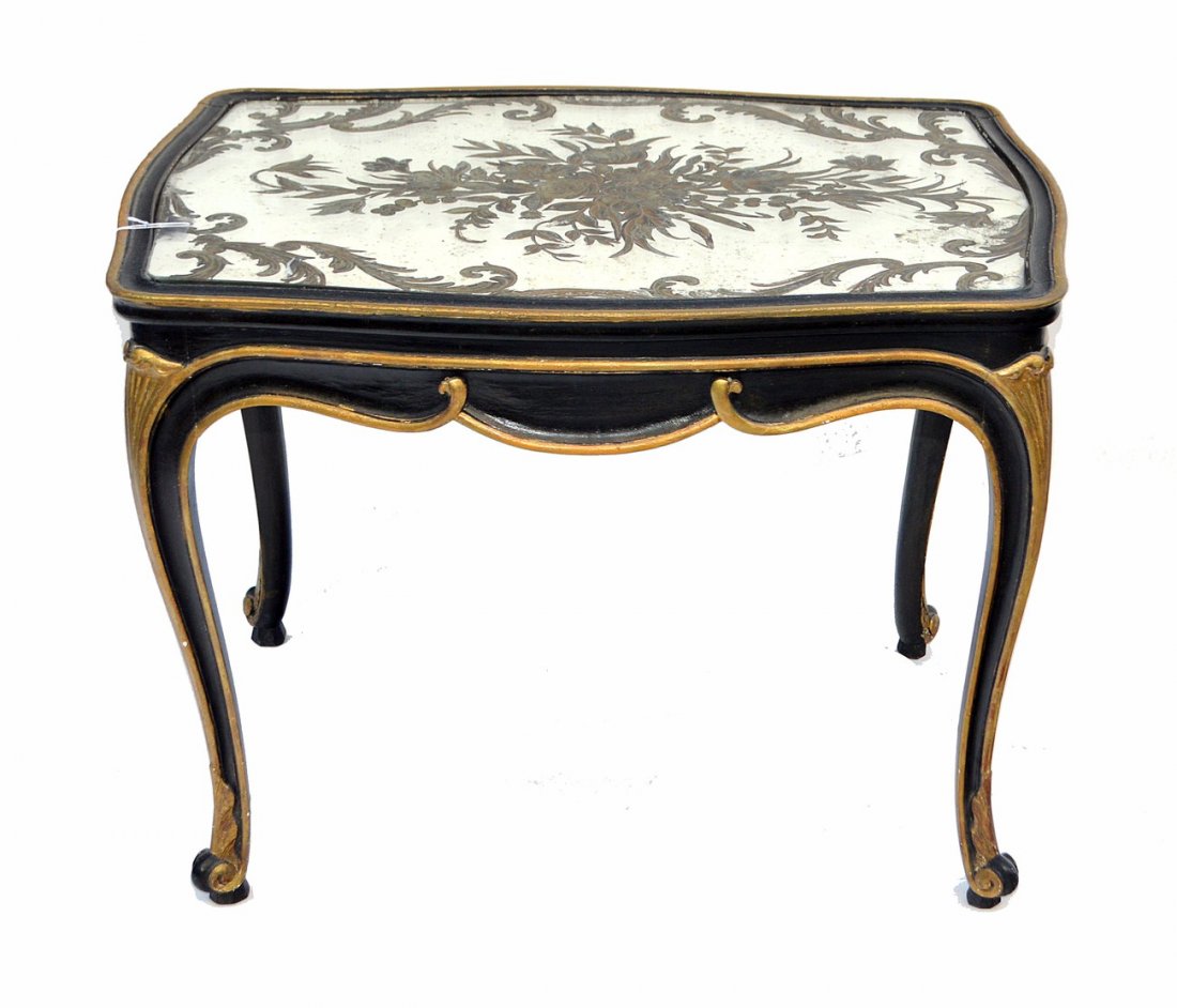 Louis XV-Style Mirror Top Coffee Table: Features verre eglomise mirror top with floral bouquet center. Bears ebonized and parcel gilt supports. 27" W x 20 1/4" D x 19 1/4" H. Mirror bears age stains.