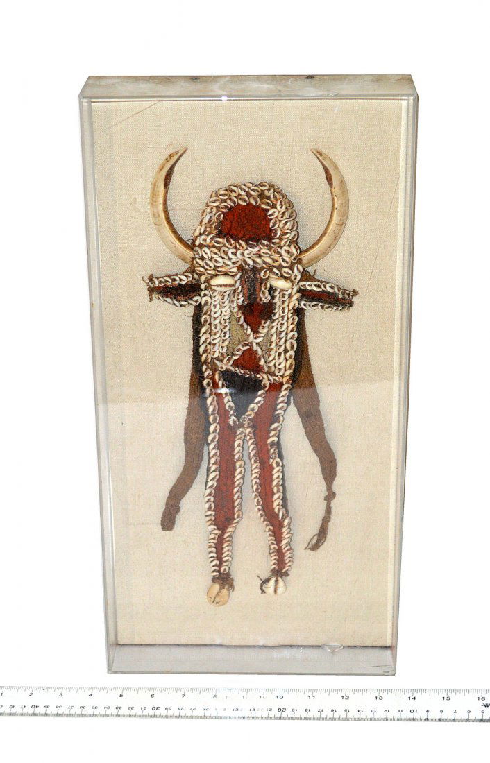 Native American Buffalo Head Ornament: Comprises woven textile with applied shells and animal tusks. 5 3/4" W x 2 1/8" D x 15" H. In good vintage condition. Mounted in a larger clear acrylic case. As is.